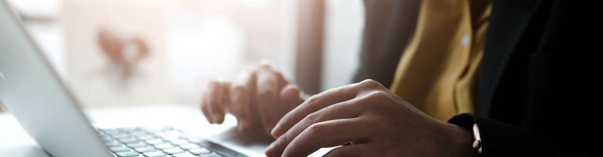 Person sitting in front of laptop.