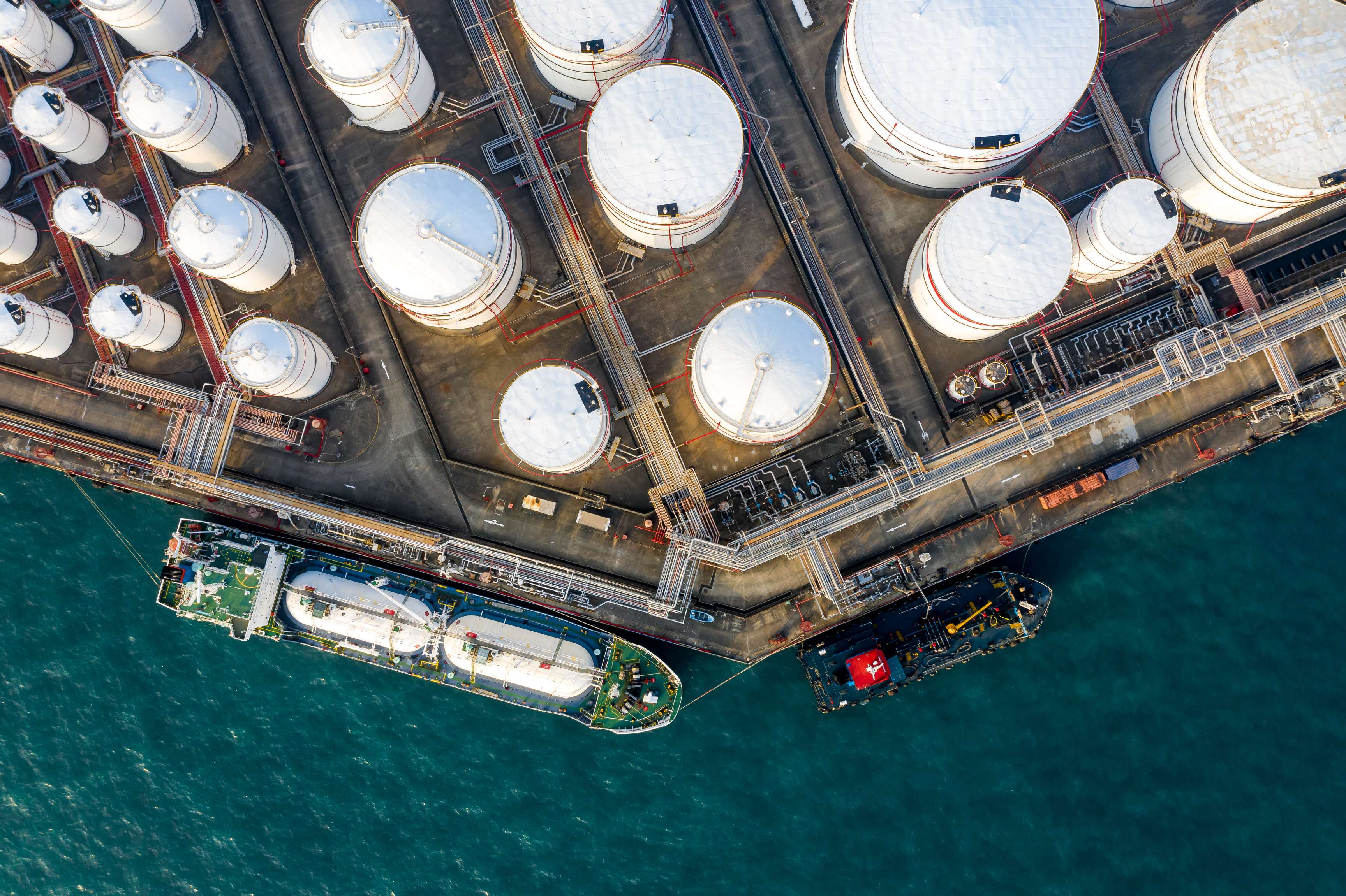 Bird's eye view of white tanks of different sizes.