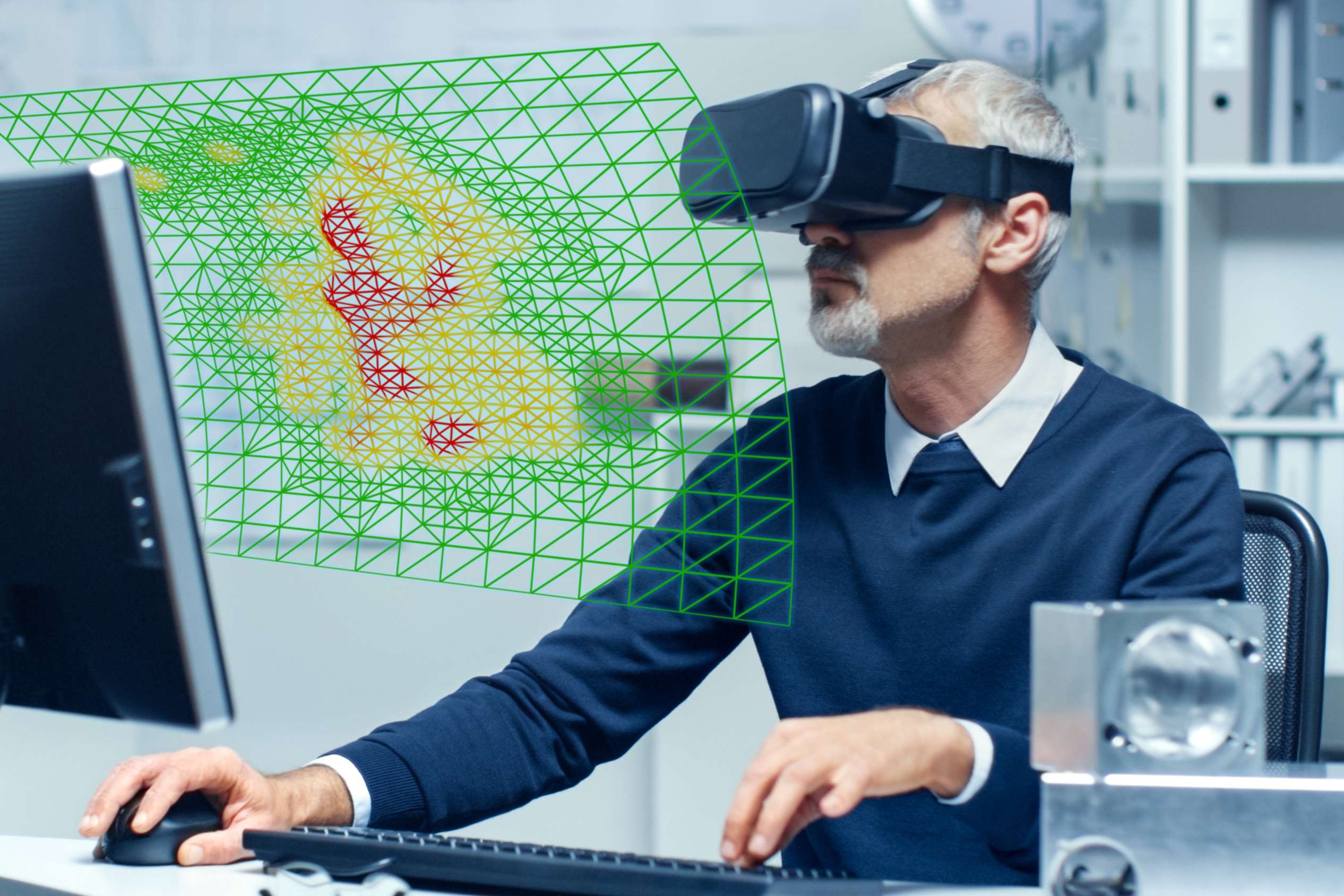 Employee wears VR-glasses, in front of him are abstractly depicted the outlines of a pipeline.