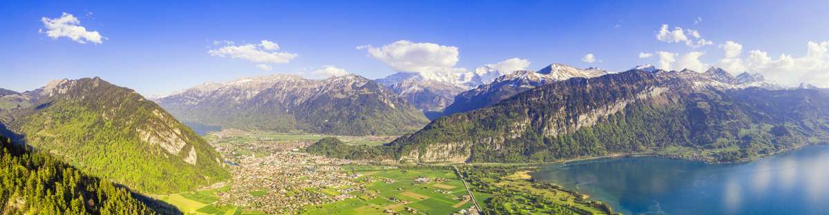Stunning panorama of the Interlaken region with lake Thun and the Jungfrau peak in the Berner Oberland in Switzerland.