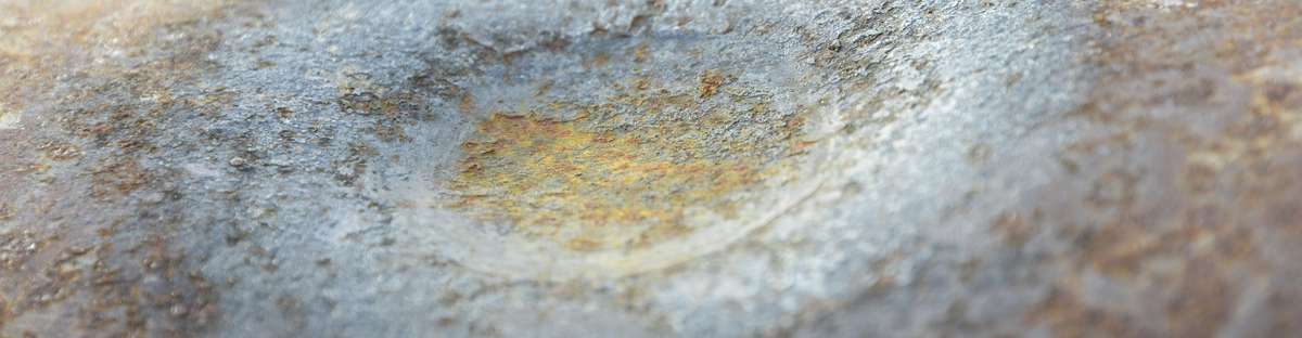 Close up of a dent in the surface of a pipeline.