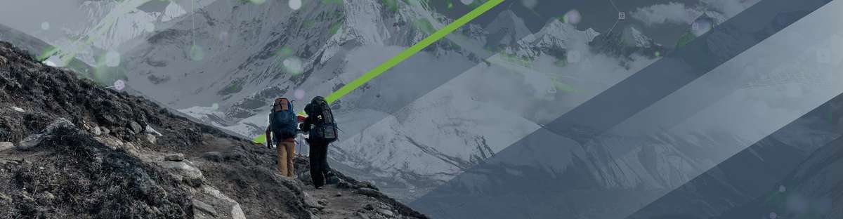 The backs of two mountaineers climbing a mountain while carrying each a big backpack.