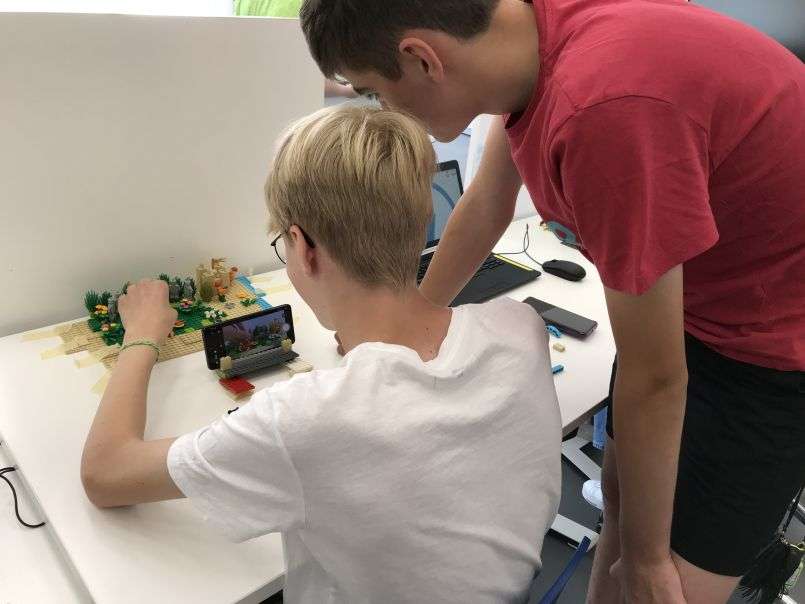 Two students creating a stop motion film using LEGO©