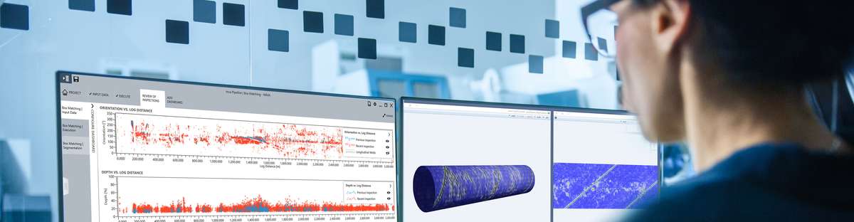 Back view of a female employee working at a computer an looking at data regarding one specific pipeline.