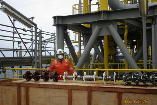Person stands on FPSO in front of tools.