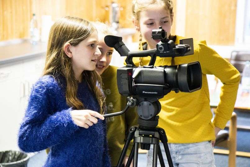 Three girls learning how to film during Movie AG at ROYOUTH