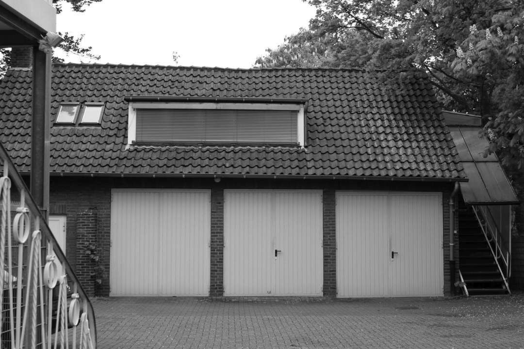 Old black and white picture of a garage.