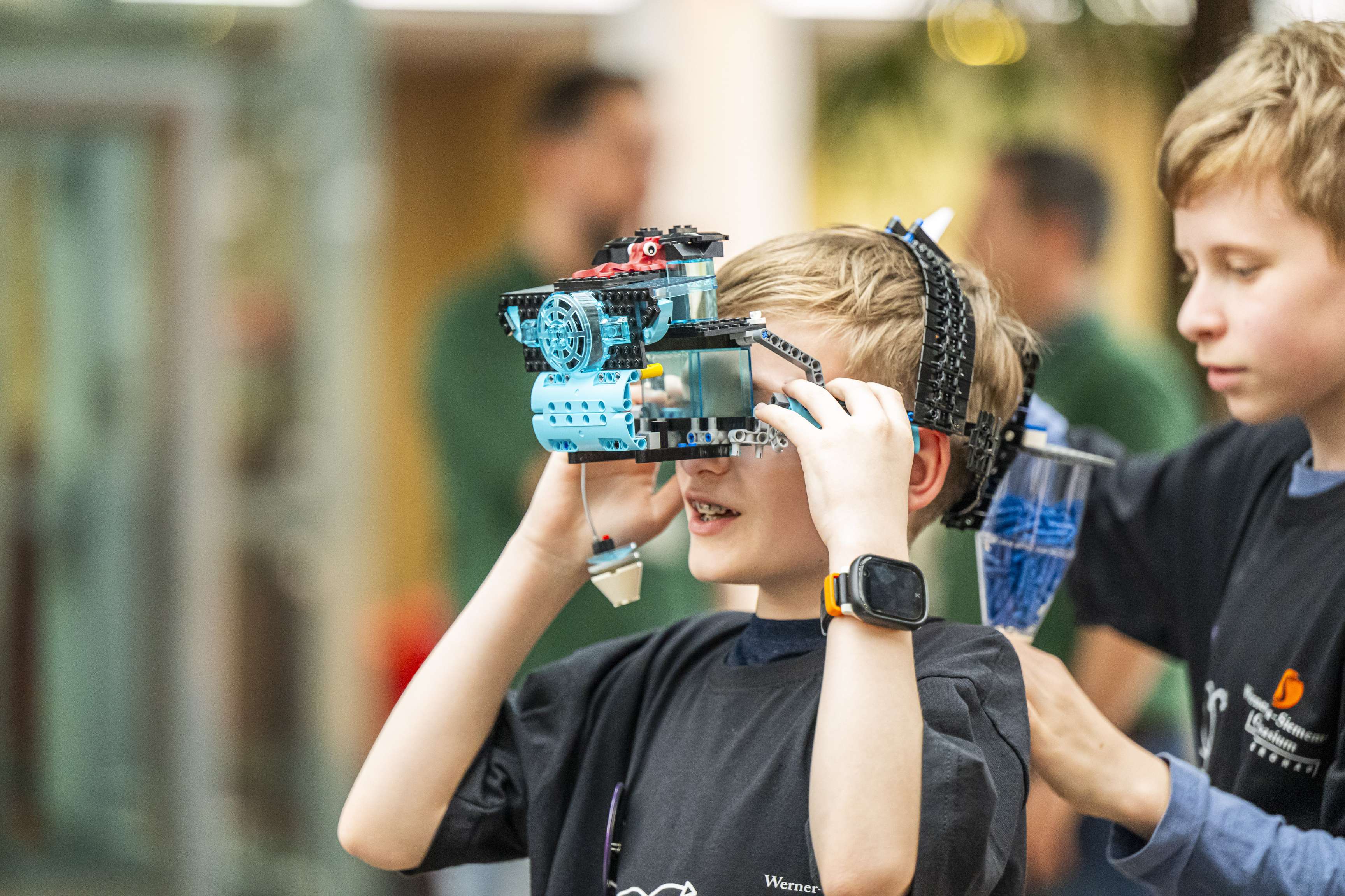 Boy wearing VR glasses made from Lego.
