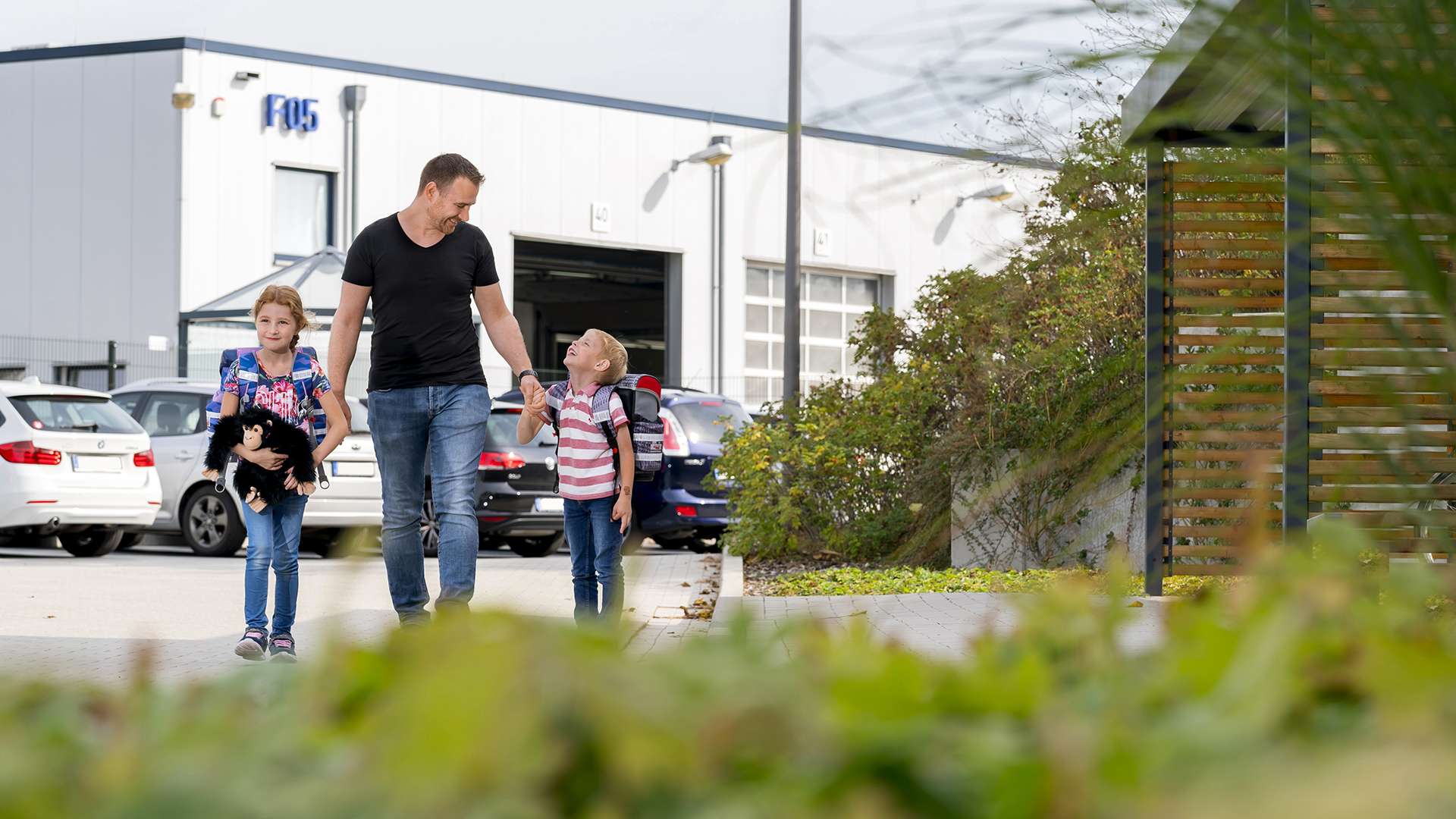 A ROSEN employee walks to ROBIGS with his two children.