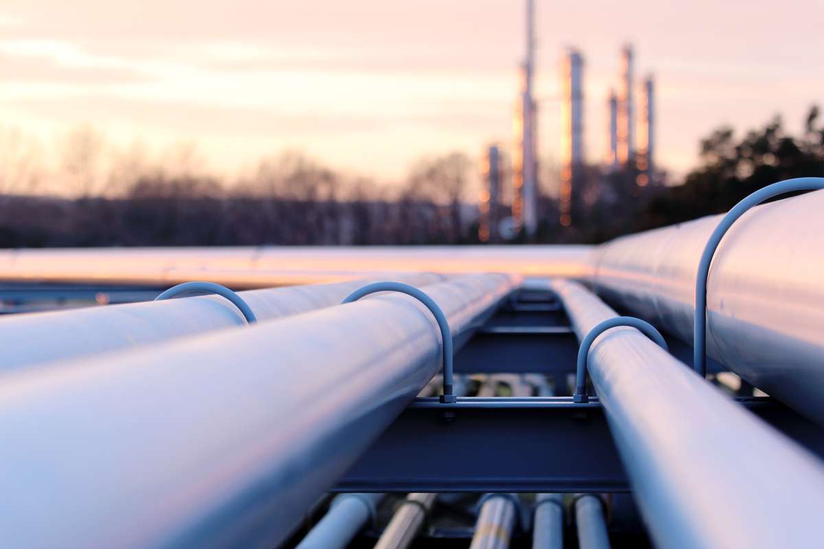 Close up of several pipelines with sunset in the background.