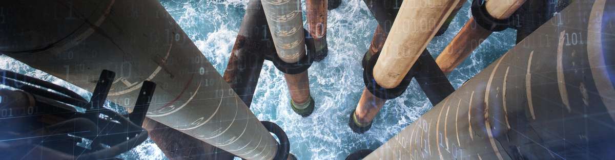 Aerial view of a platform in the sea where you can see the sea between the pillars.
