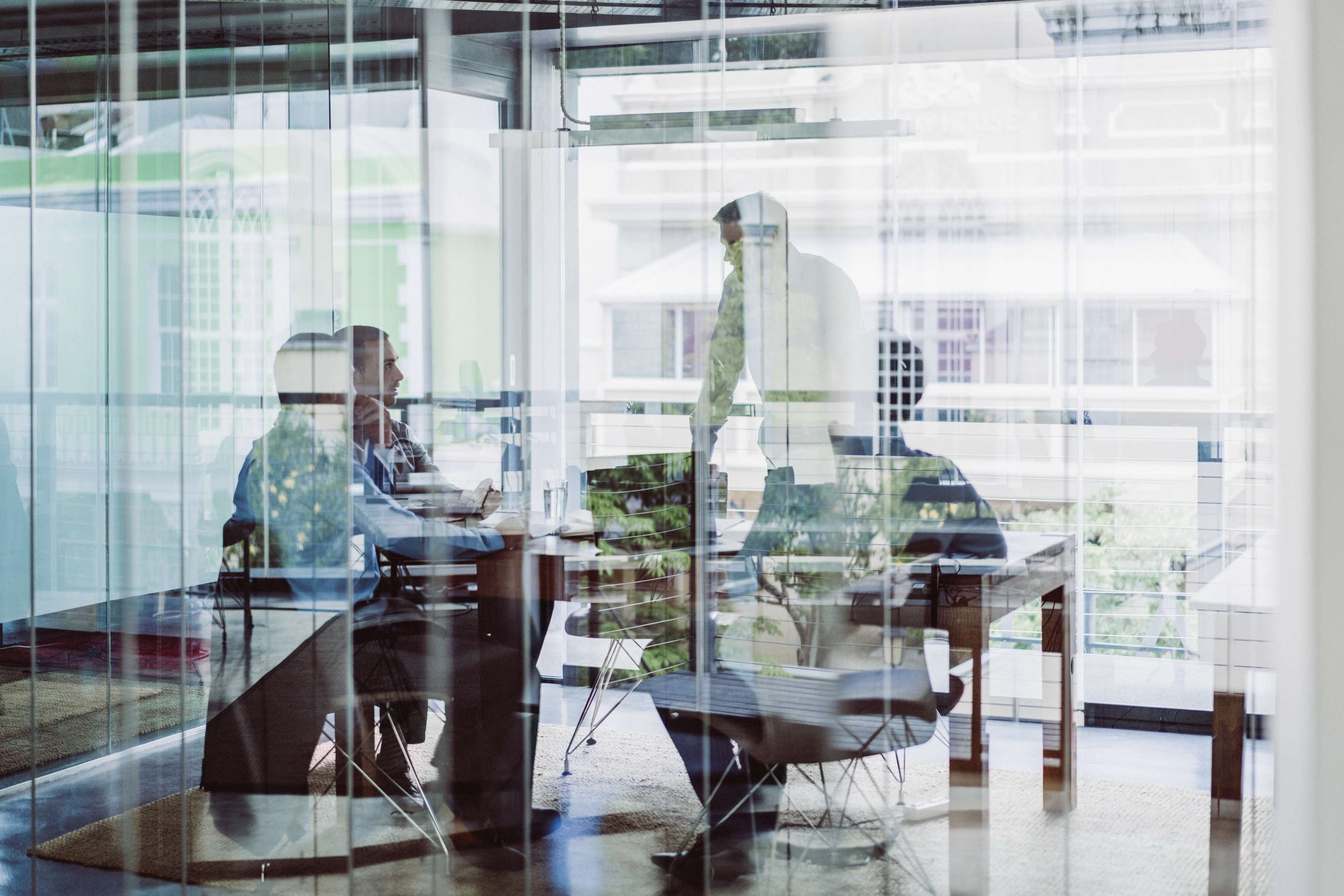 Group of business people sitting together in a meeting room.