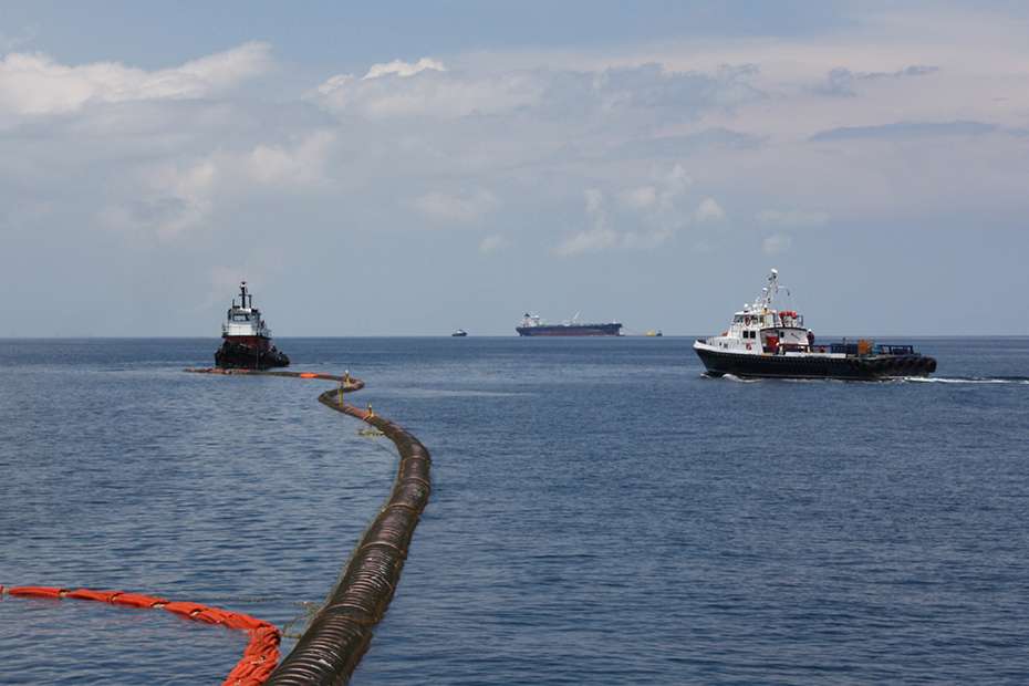 Loading line in the sea leads to a ship.