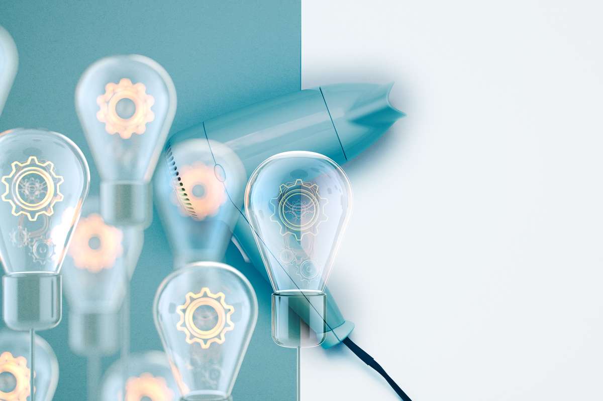 Light bulbs with technical illustrations in front of hair dryer with blue background.