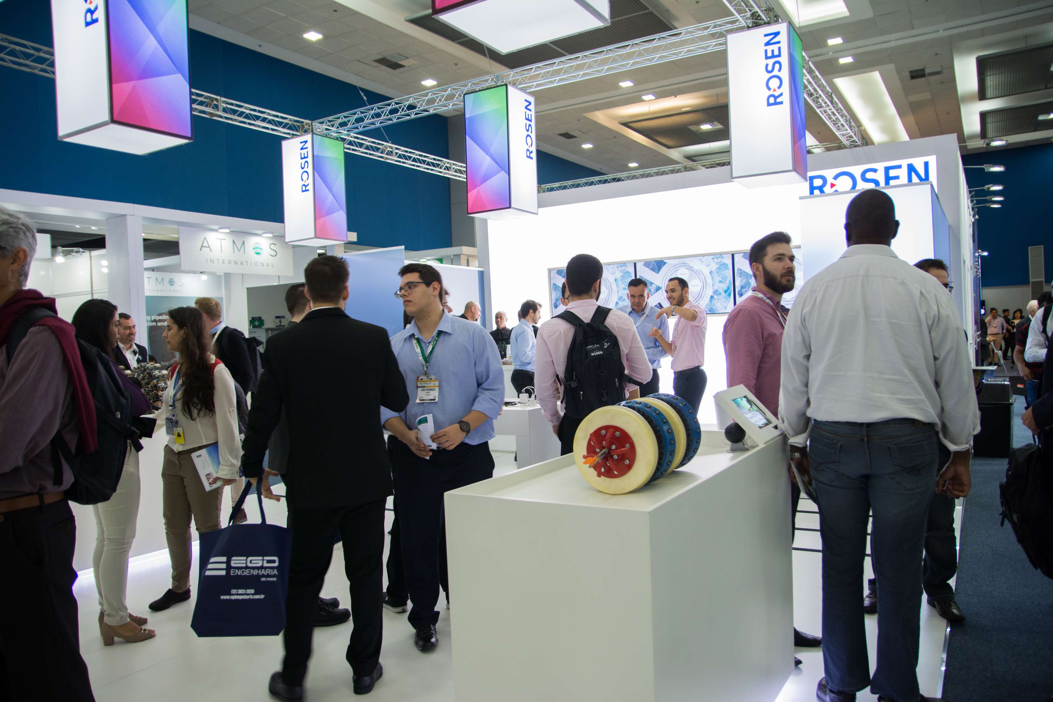 people gathering at a ROSEN booth at Rio Pipeline Conference