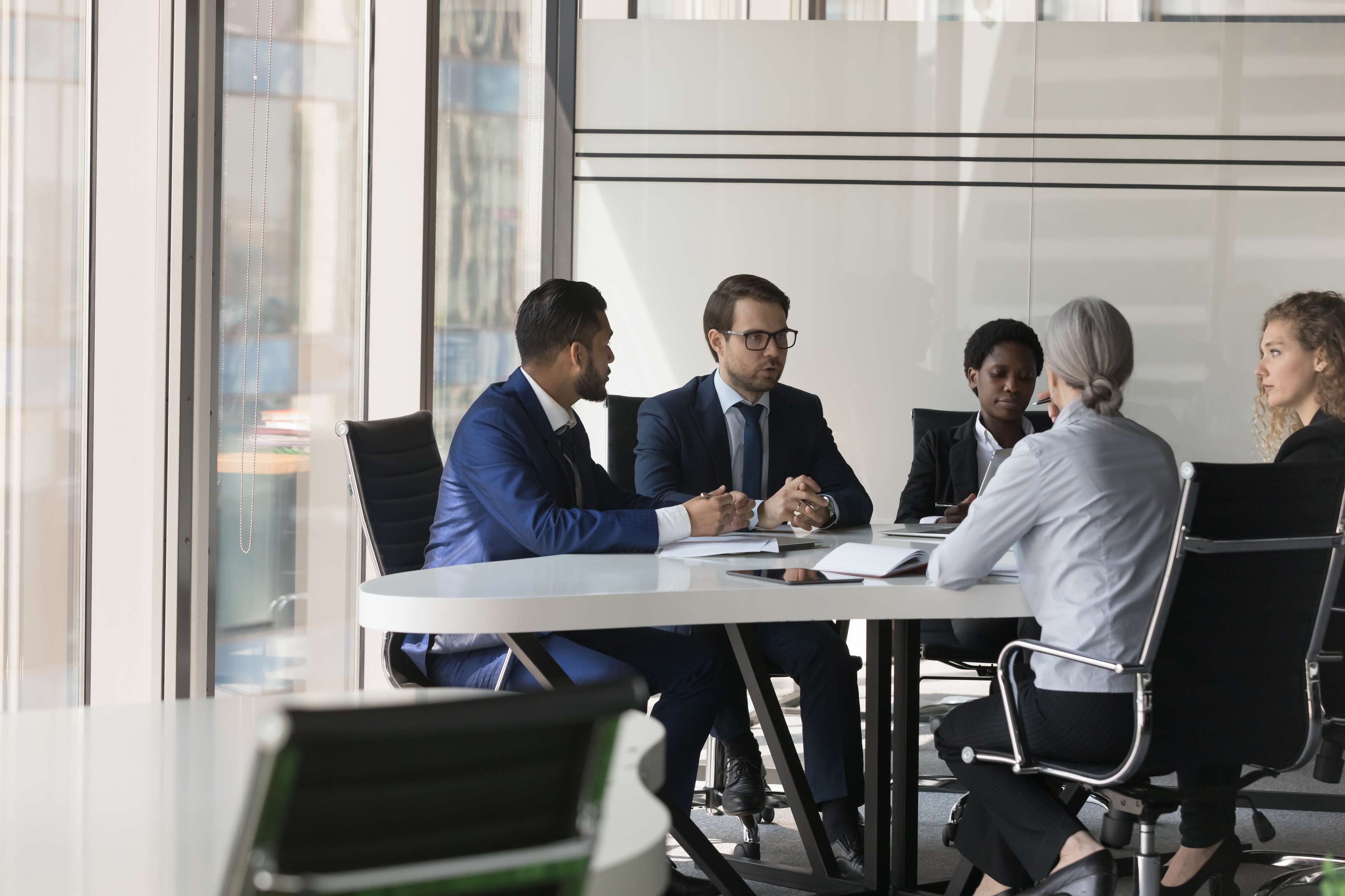 Group of business people sitting at a table.