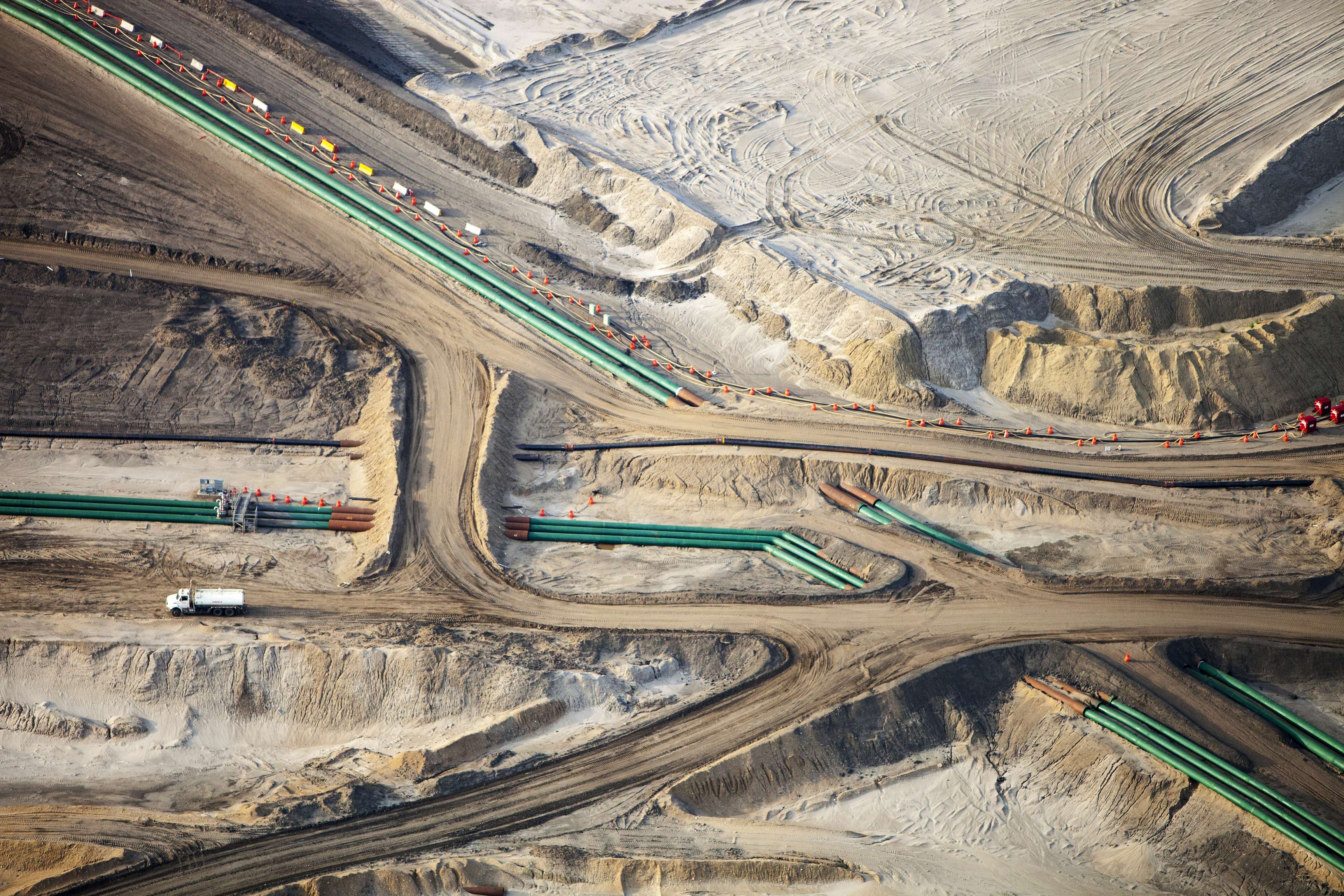 Pipelines with branches leading through a desert-like landscape.