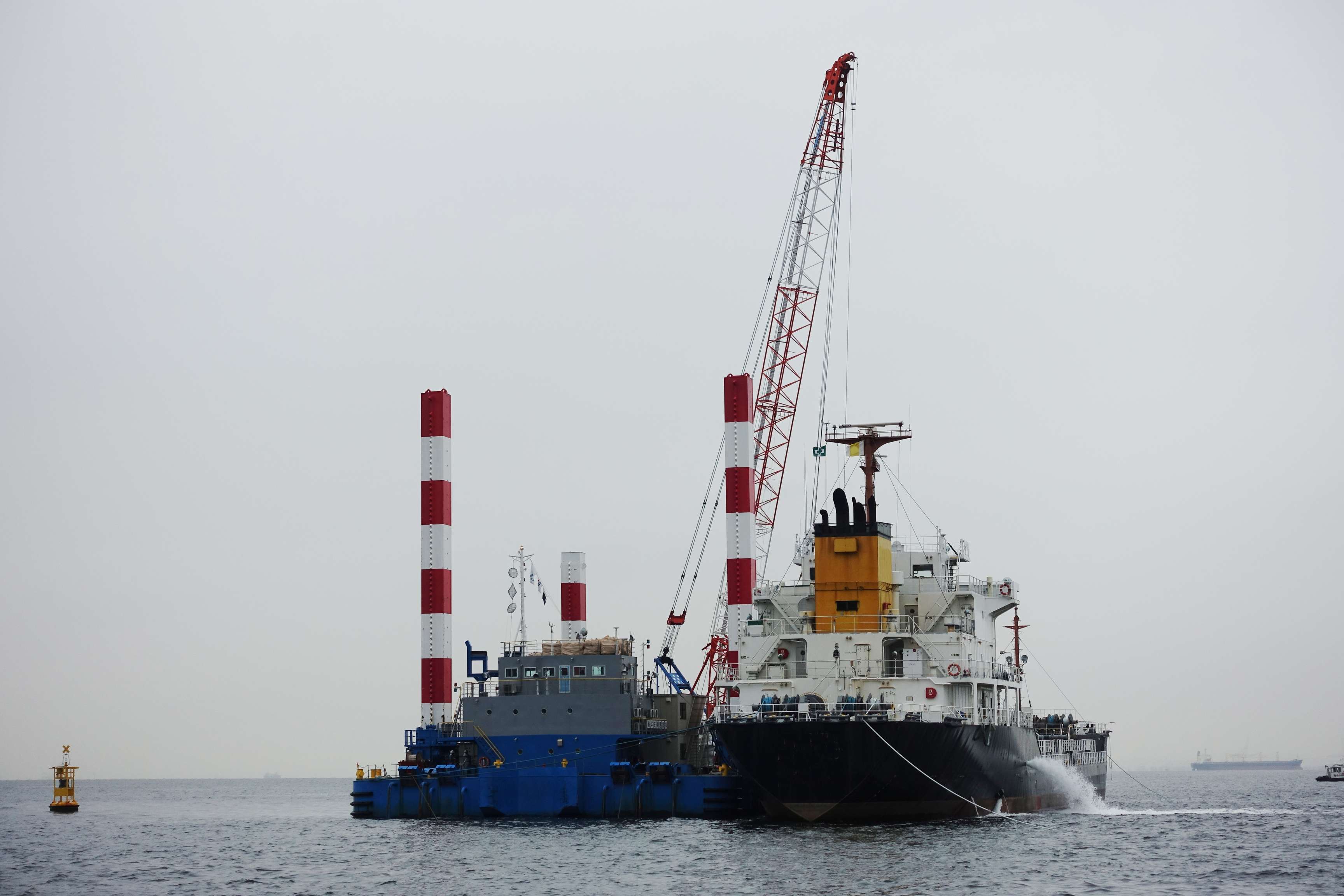 Sea-going vessel with crane extended.