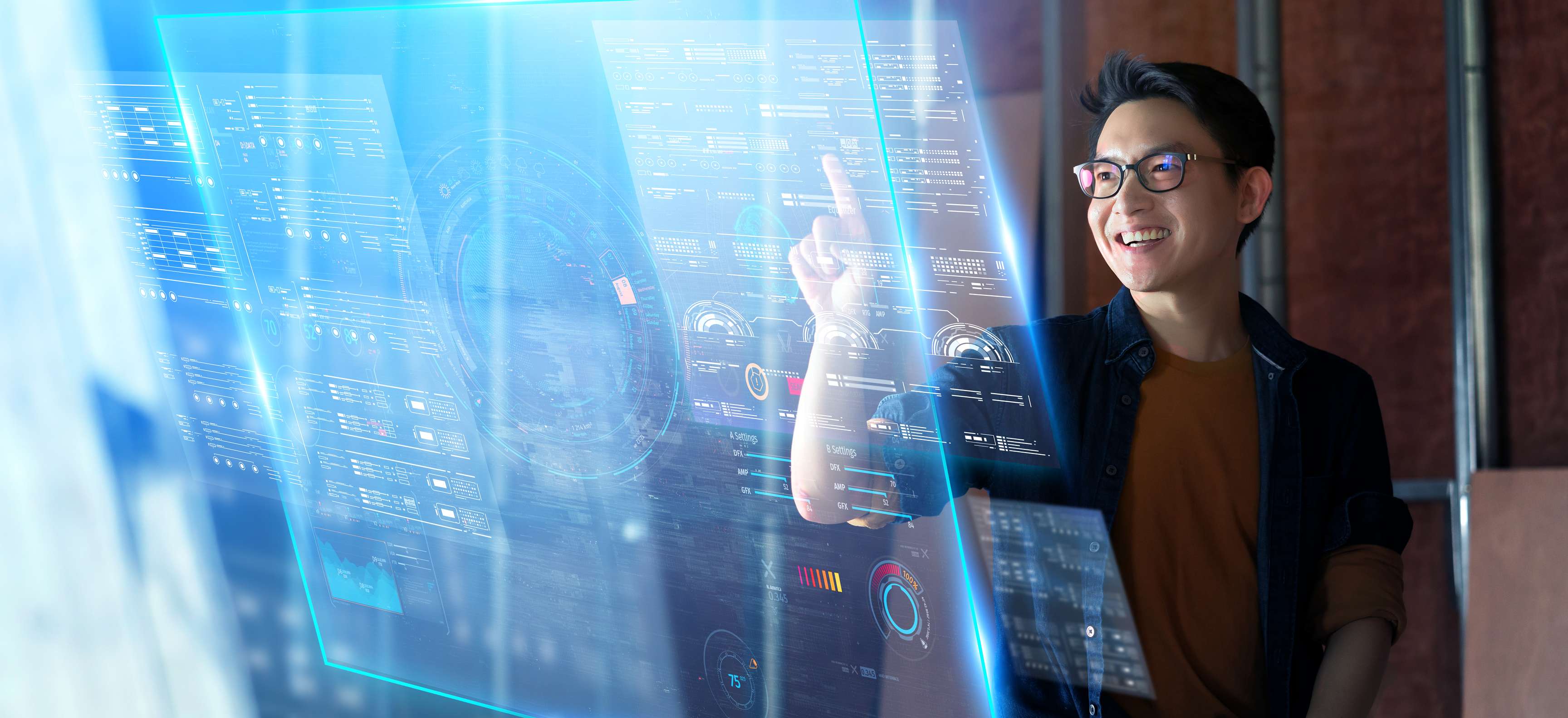 Young asian employee stands in front of virtual screen showing complex data.