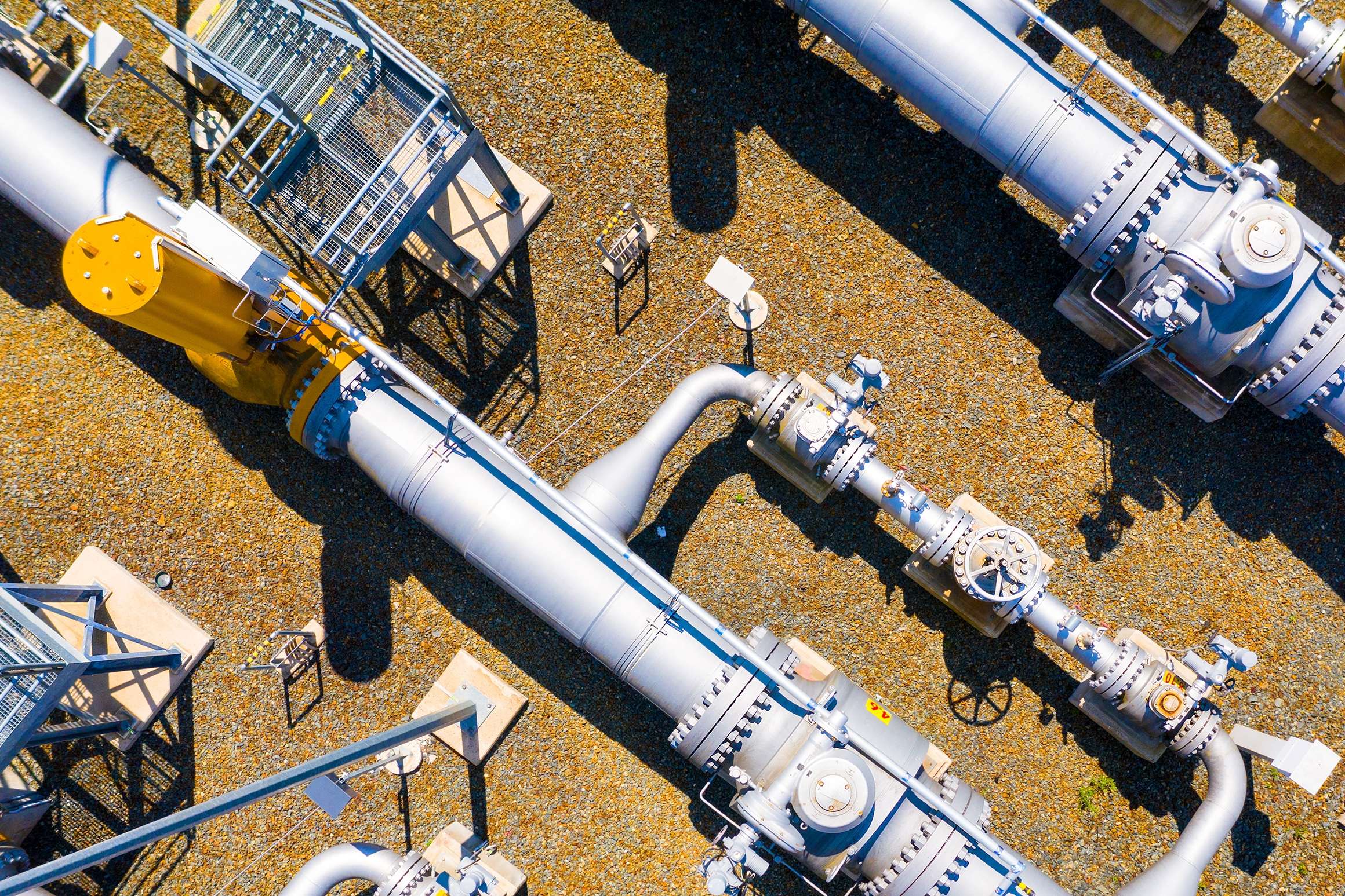 Aerial view of several pipelines and their access points next to each other.