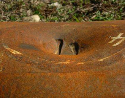 Picture of a dent with metal loss leading to a leak.