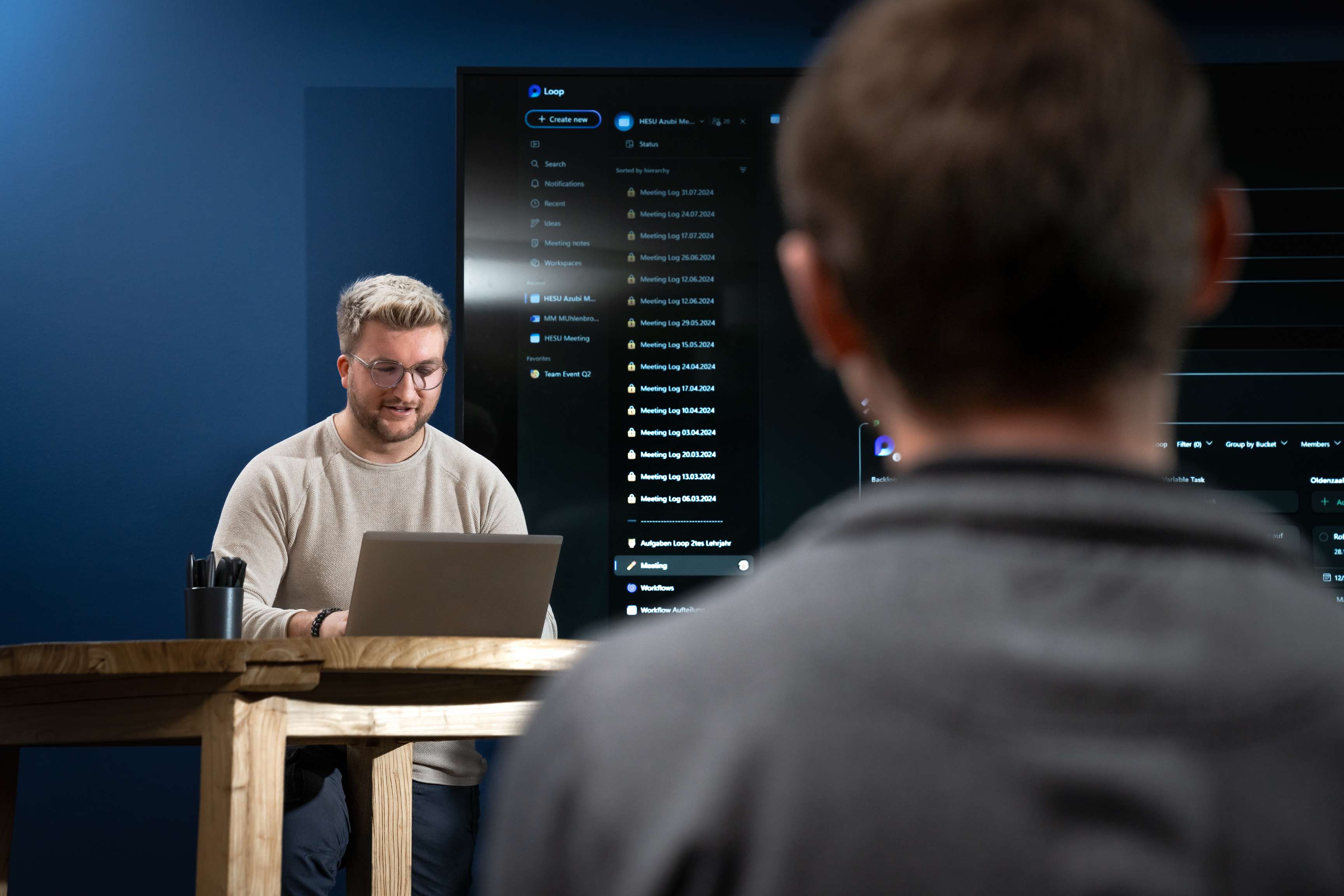 A ROSEN colleague presents to another colleague in a meeting room.