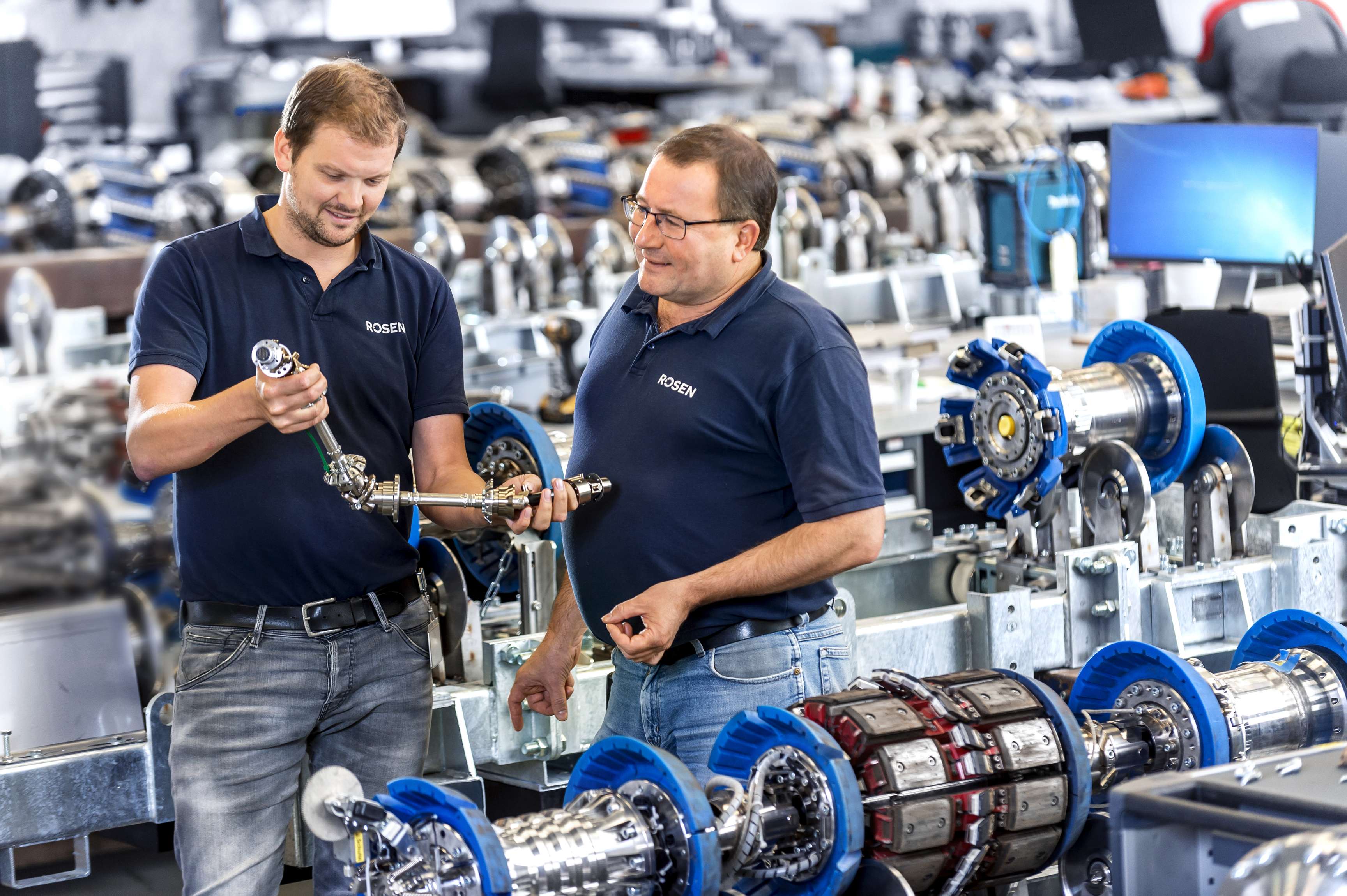 Two ROSEN employees working on an in-line inspection tool.