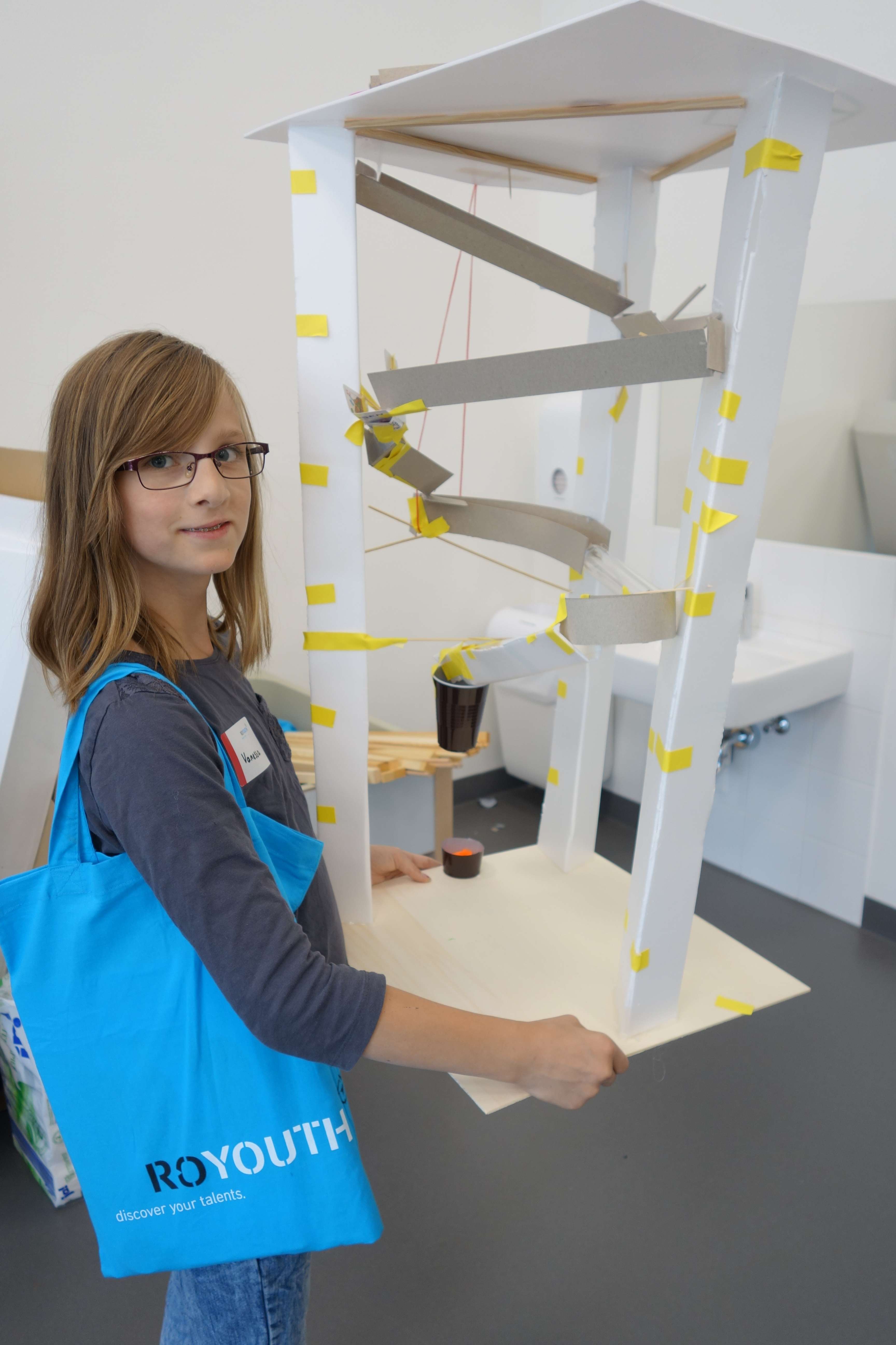 Student proudly shows off selfmade marble run