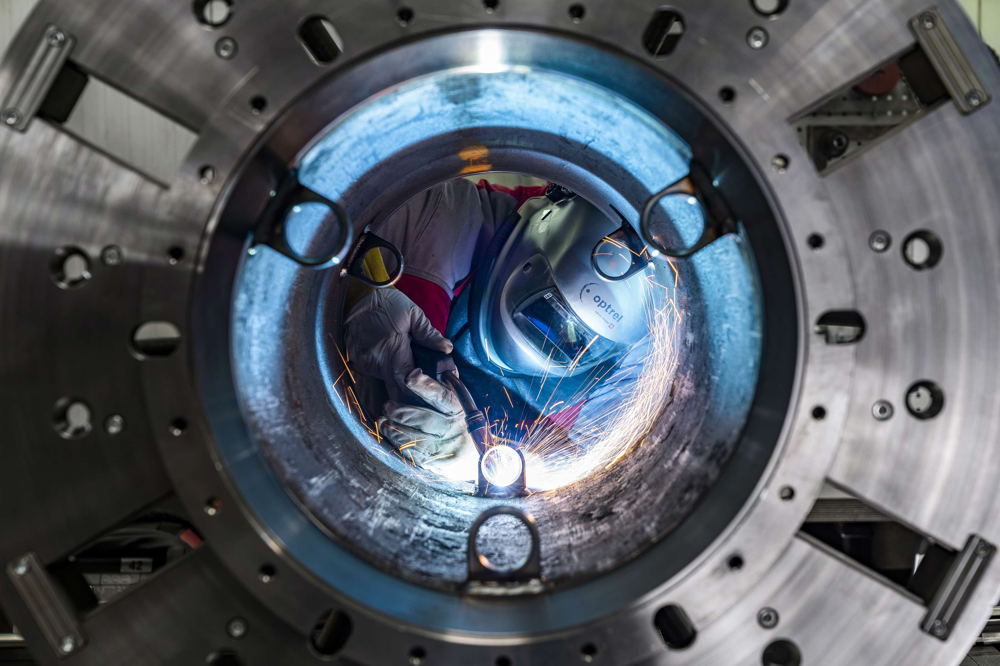 View from inside a pipeline onto a welder.