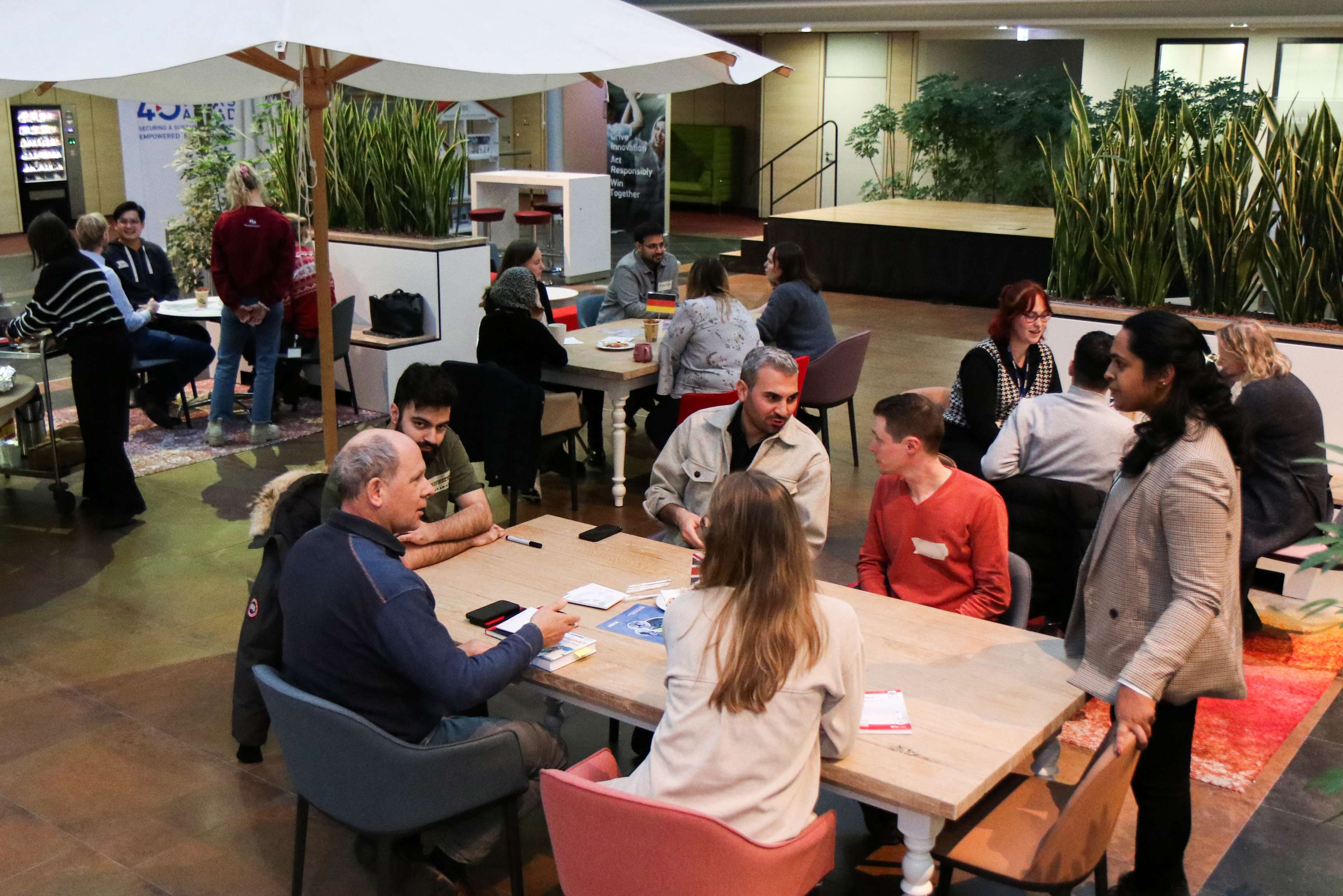 Several people sit together at tables in the ROSEN office in Lingen, Germany.