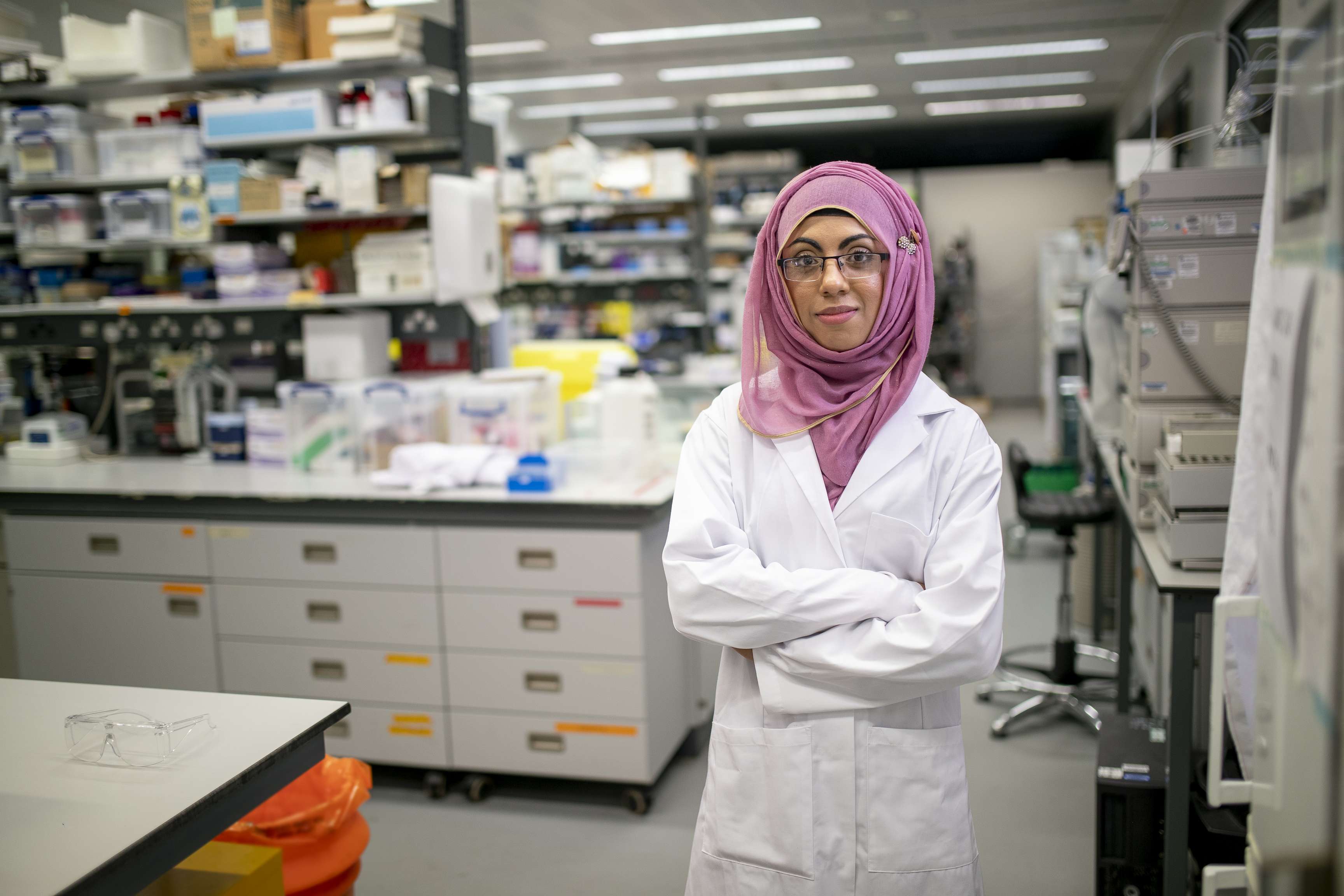 Laboratory employee in white coat.