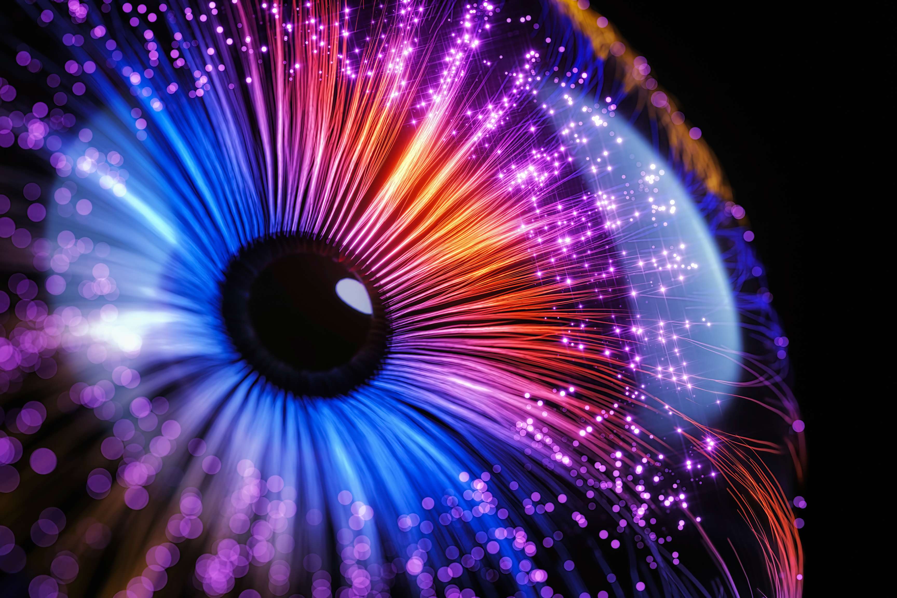 Abstract image that resembles an eye to whose black pupil lead colorful threads.