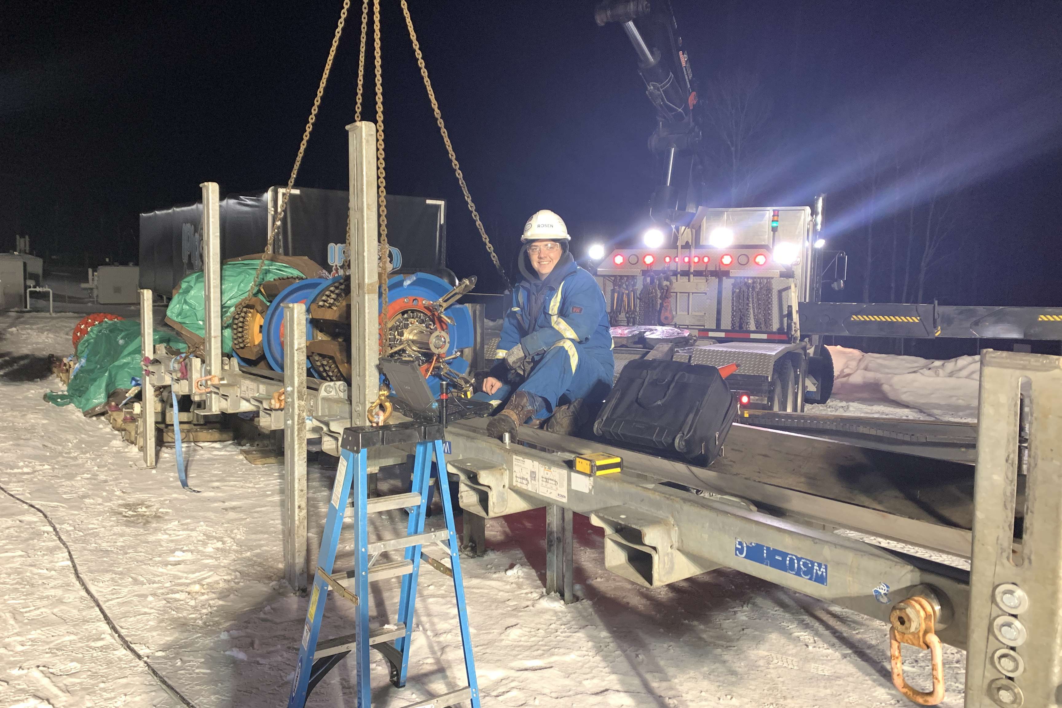 A man on site next to an in-line inspection tool.