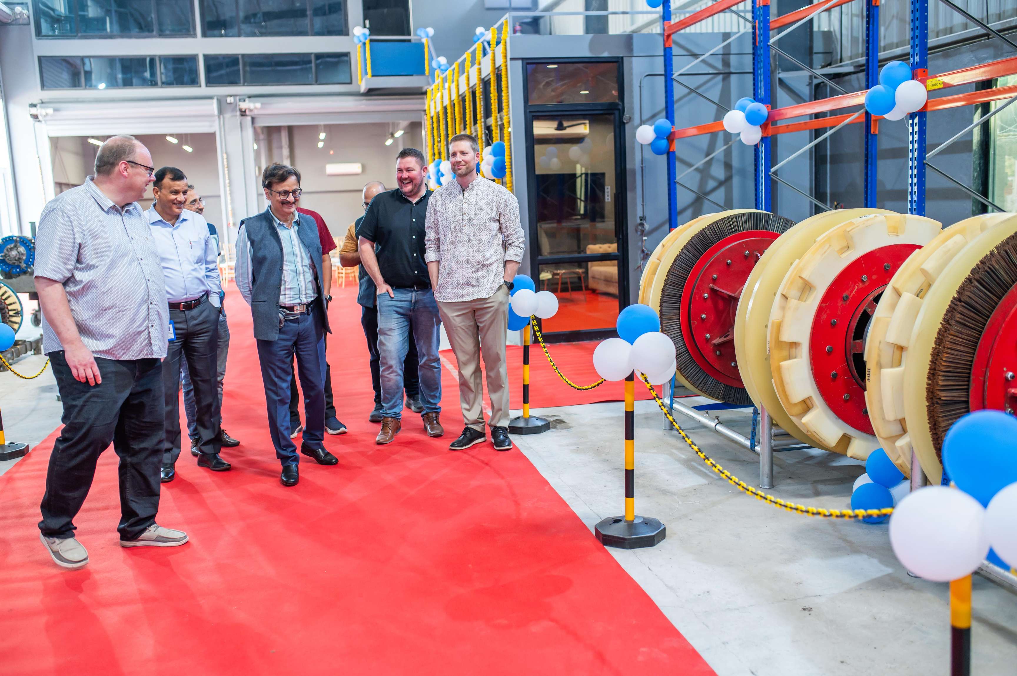 A picture from inside the new ROSEN facility in India showing various people and tools.