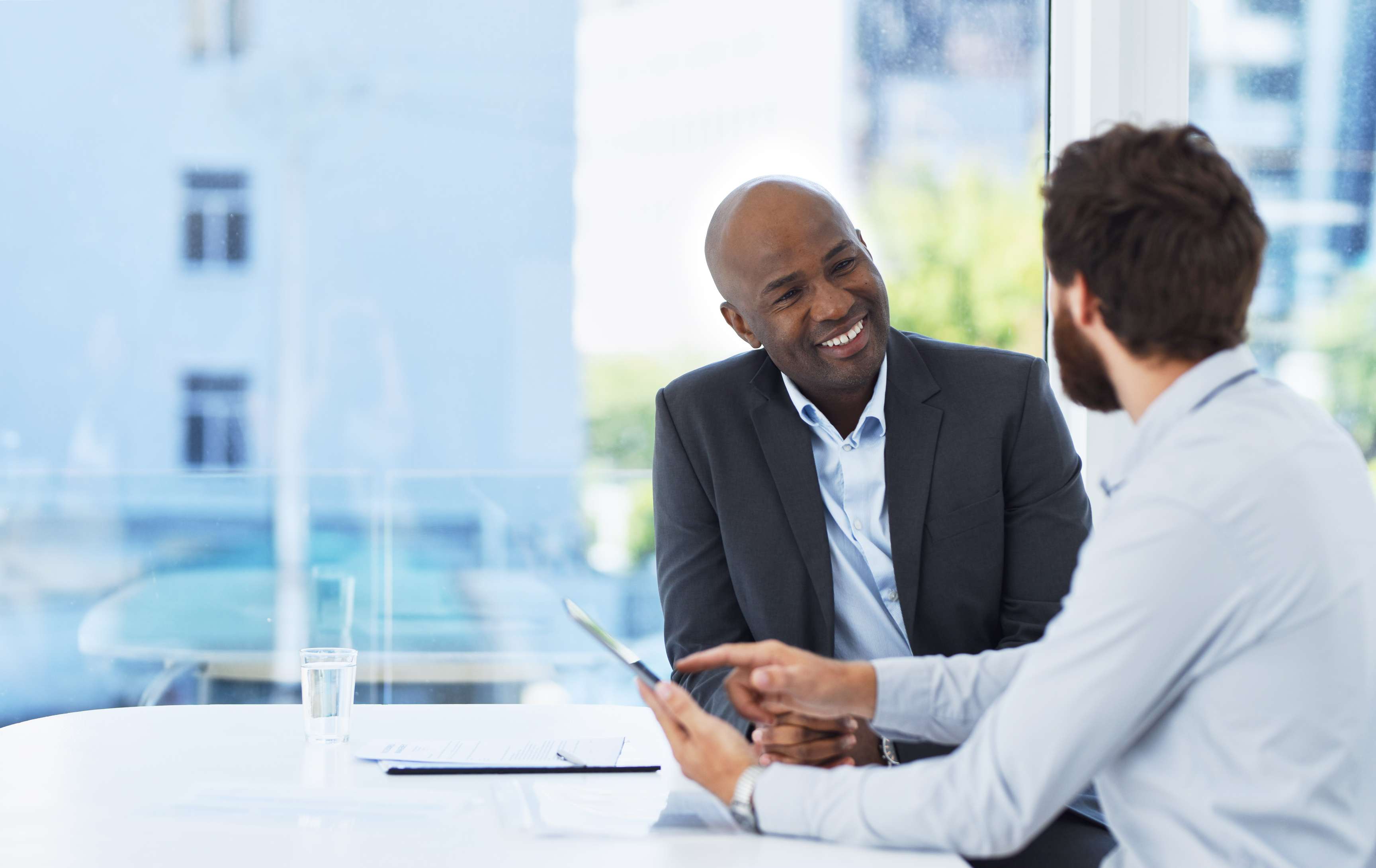 Cropped shot of two handsome businessmen having a meeting in their office boardroom.