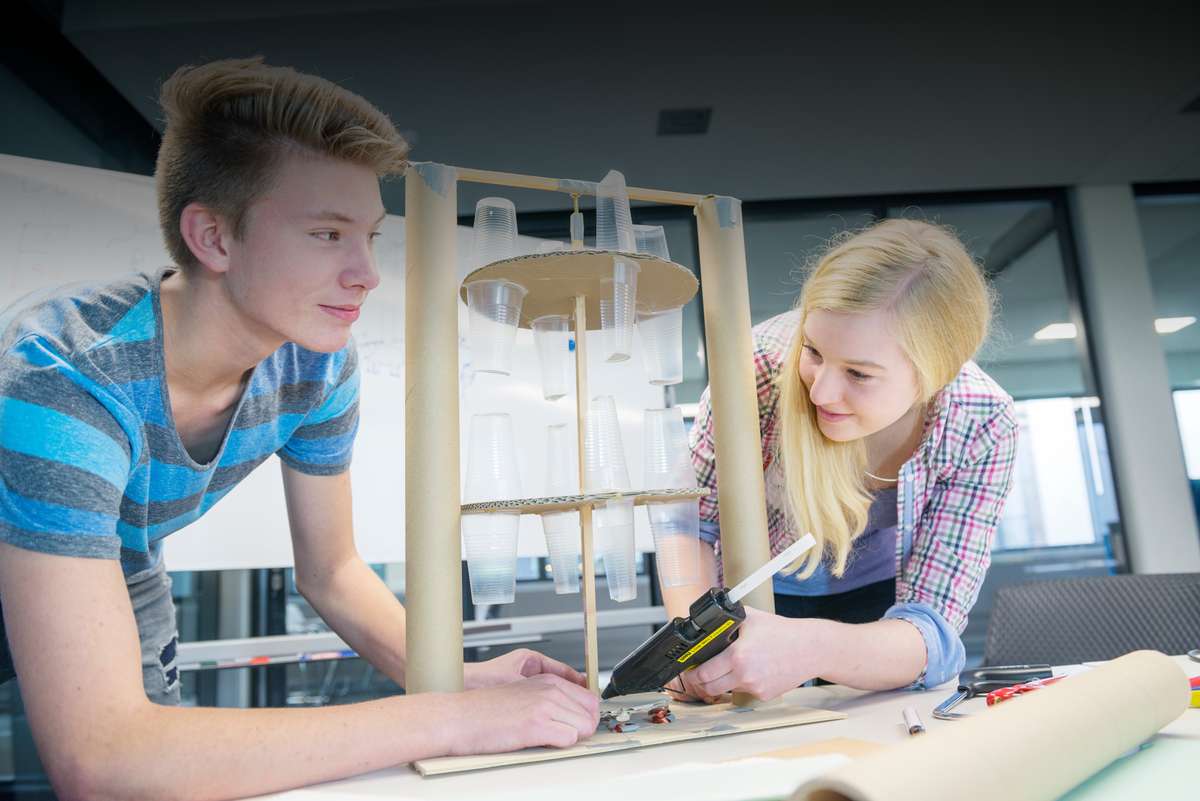 Two teenagers working on an experiment together.
