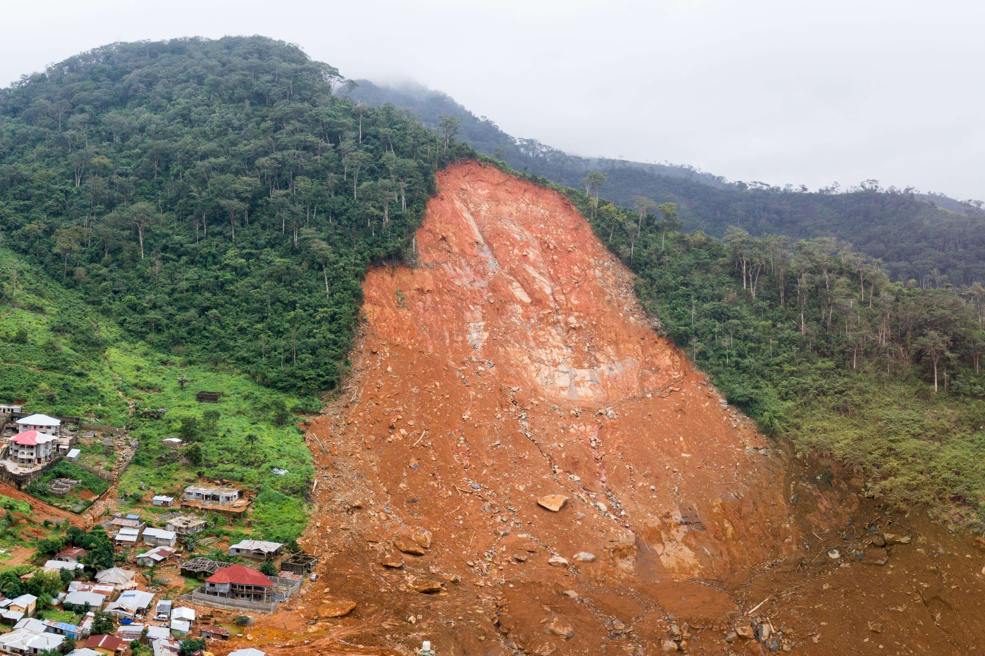 A stitched panoramic drone image showing the aftermath of a mudslide.