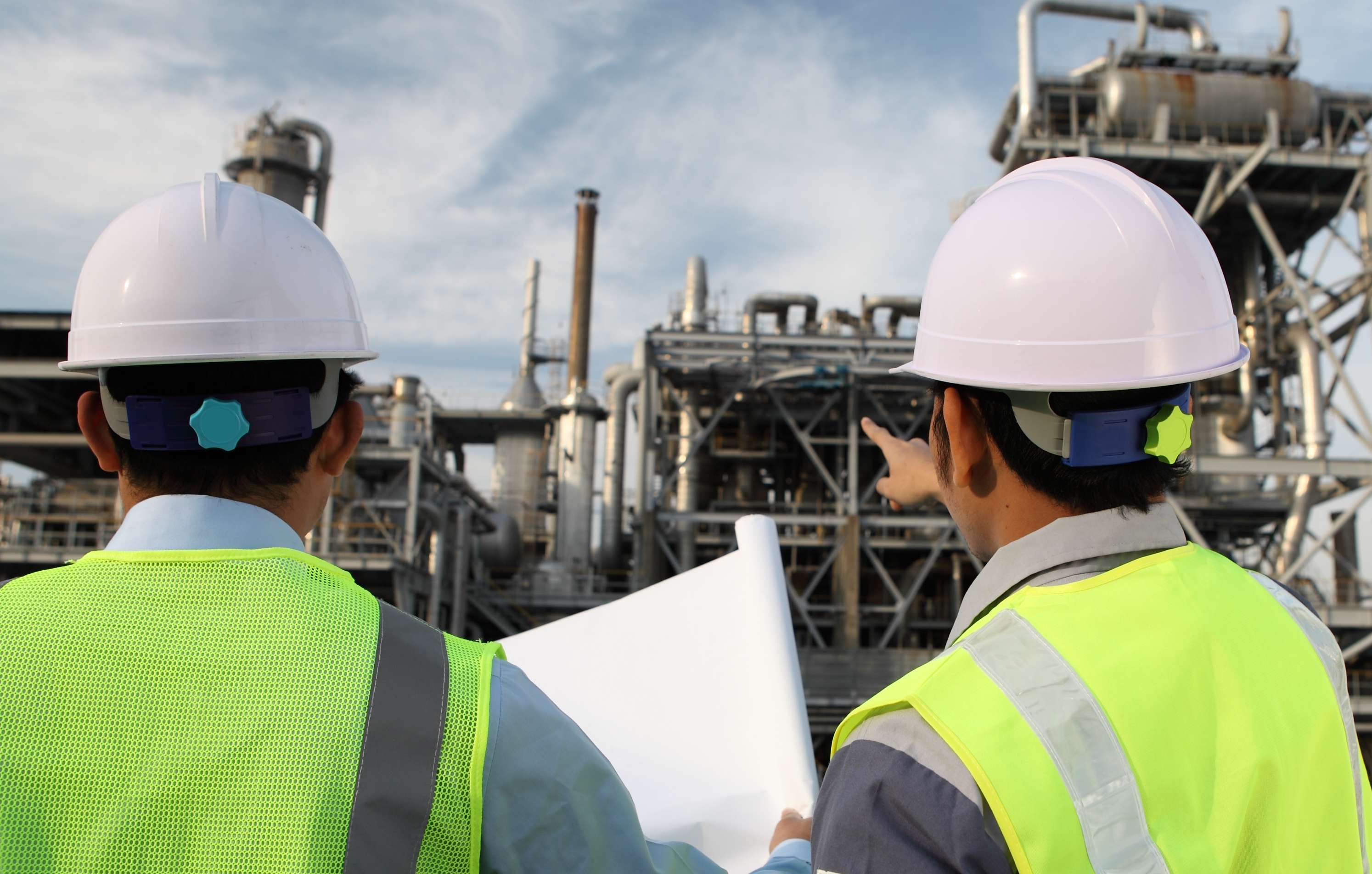 two-engineer-oil-industry-discussing-with-a-large-oil-refinery-background-rosen-group.jpg