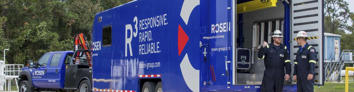 Blue R³ truck and trailer with two technicians.