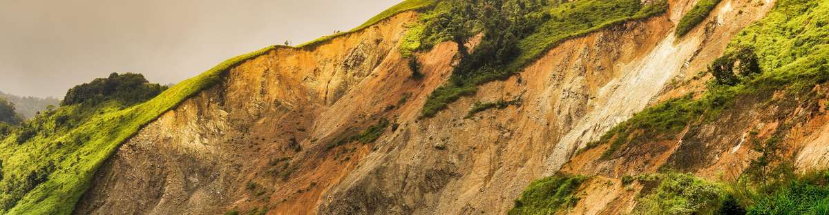 Image of the side of a mountain showing a past landslide.