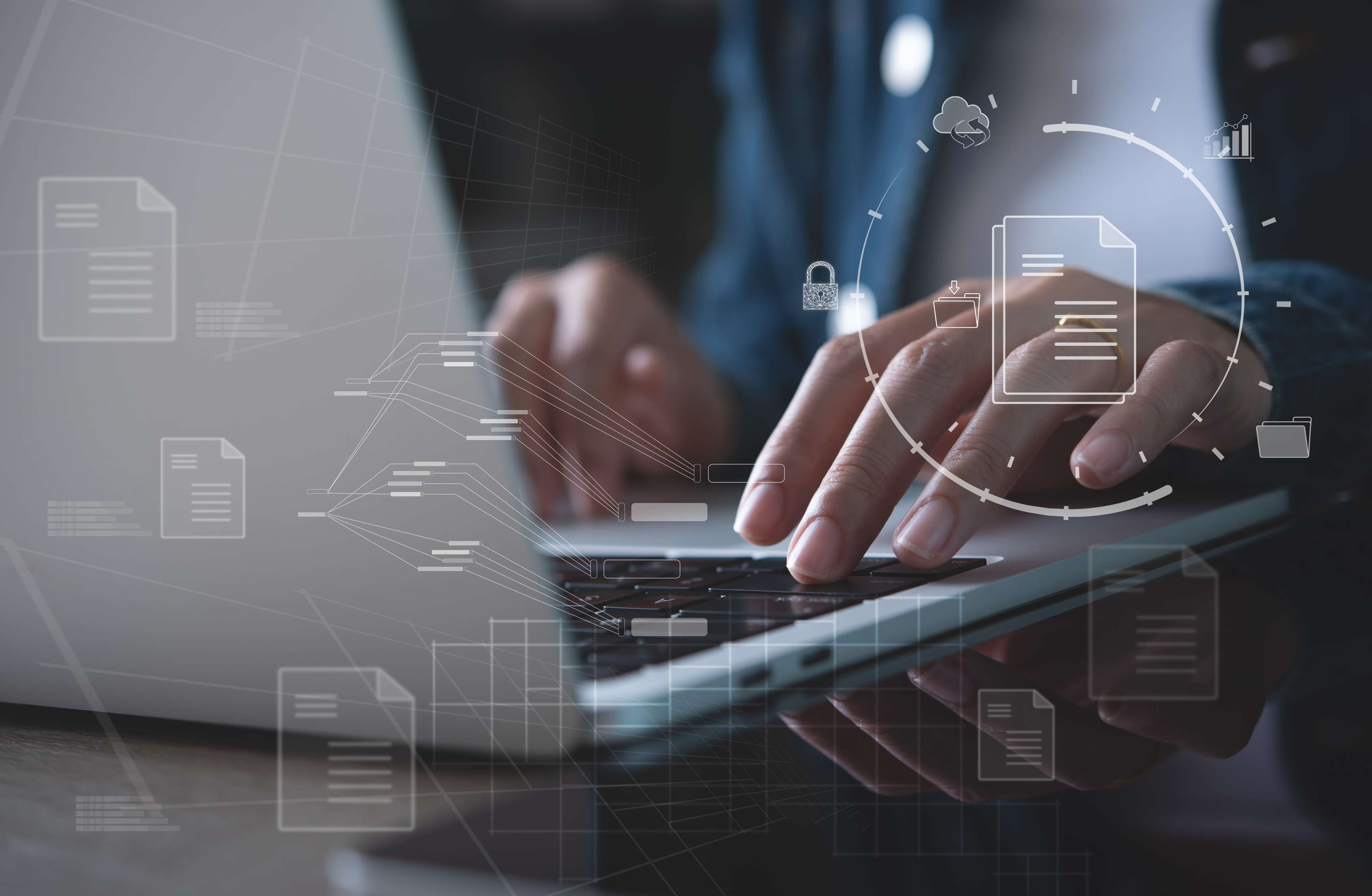 Document management system (DMS) set up by an IT consultant working on a laptop in the office. Software for archiving, searching and managing company files and information.
