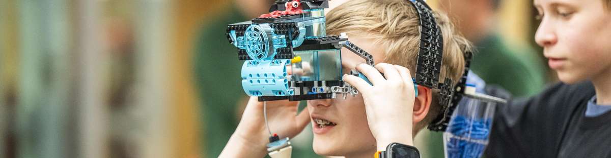 Boy wearing VR glasses made from Lego.