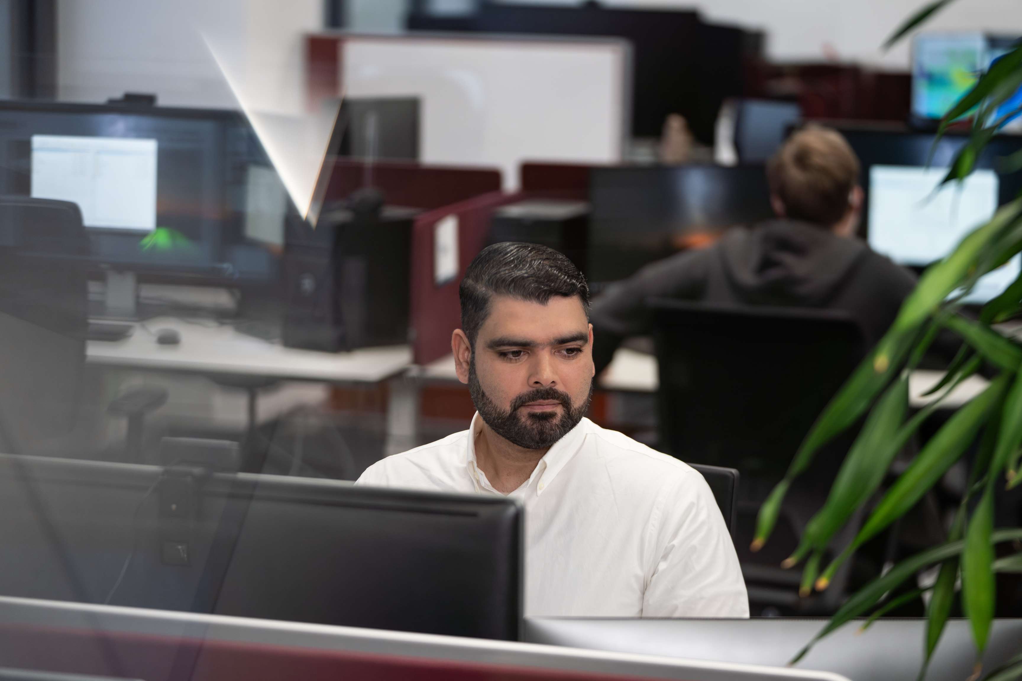 Ein ROSEN-Kollege sitzt in einem Büro vor einem Bildschirm.