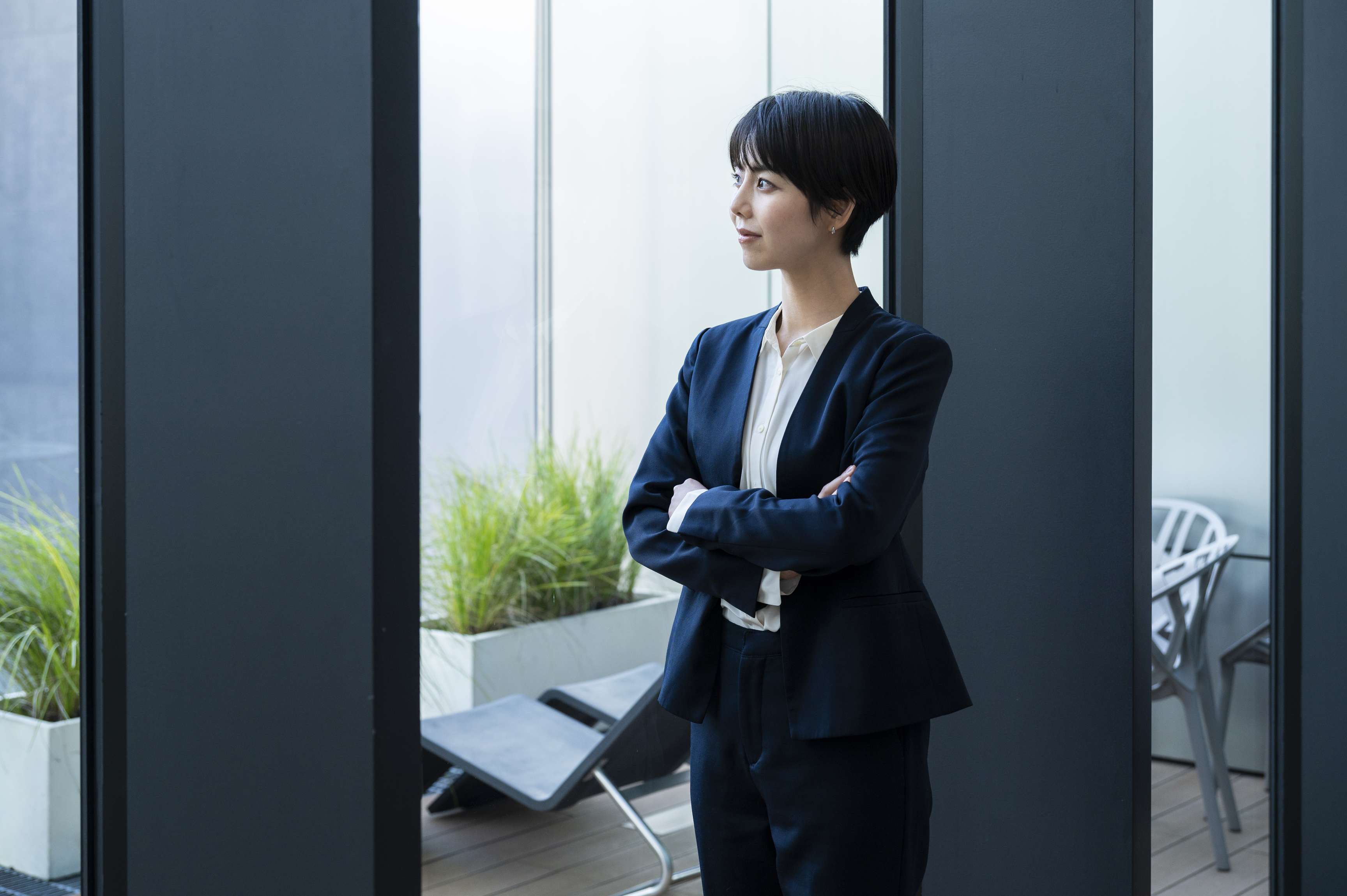 Woman in business attire standing in the office.