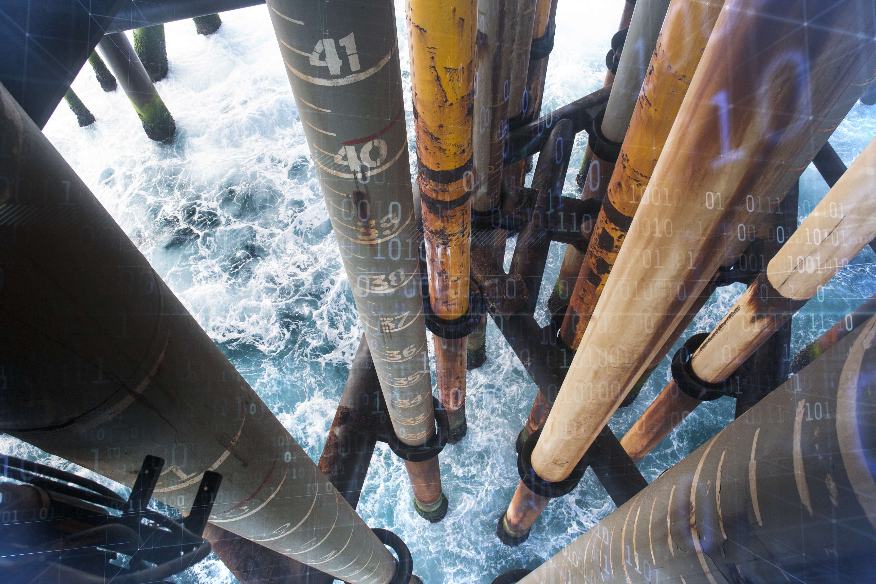 Aerial view of a platform in the sea where you can see the sea between the pillars.