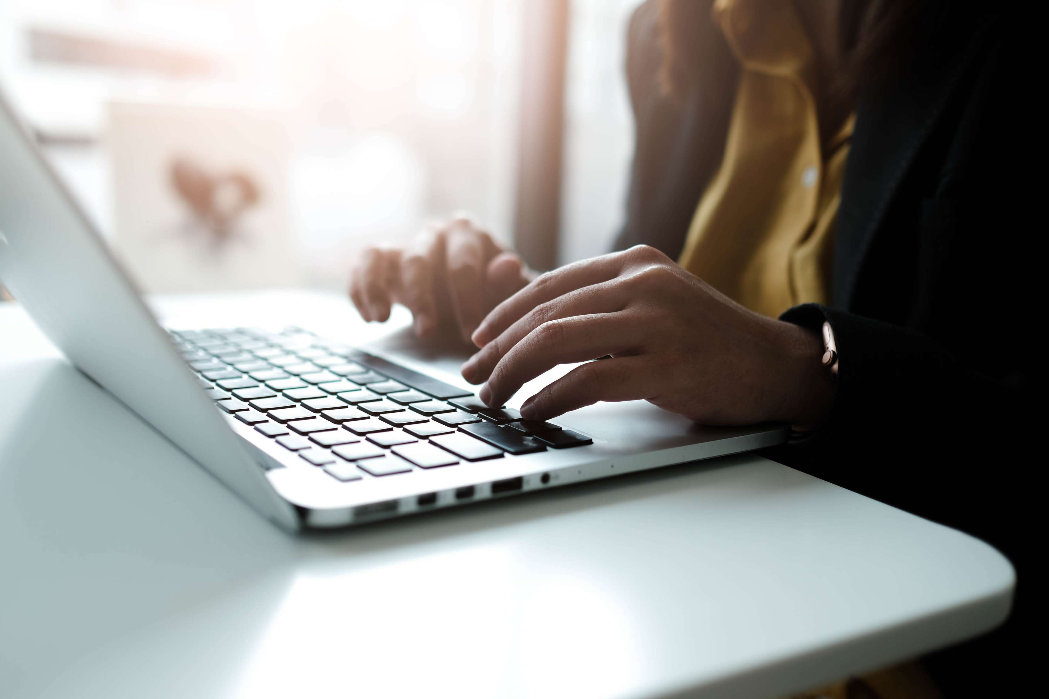 Person sitting in front of laptop.