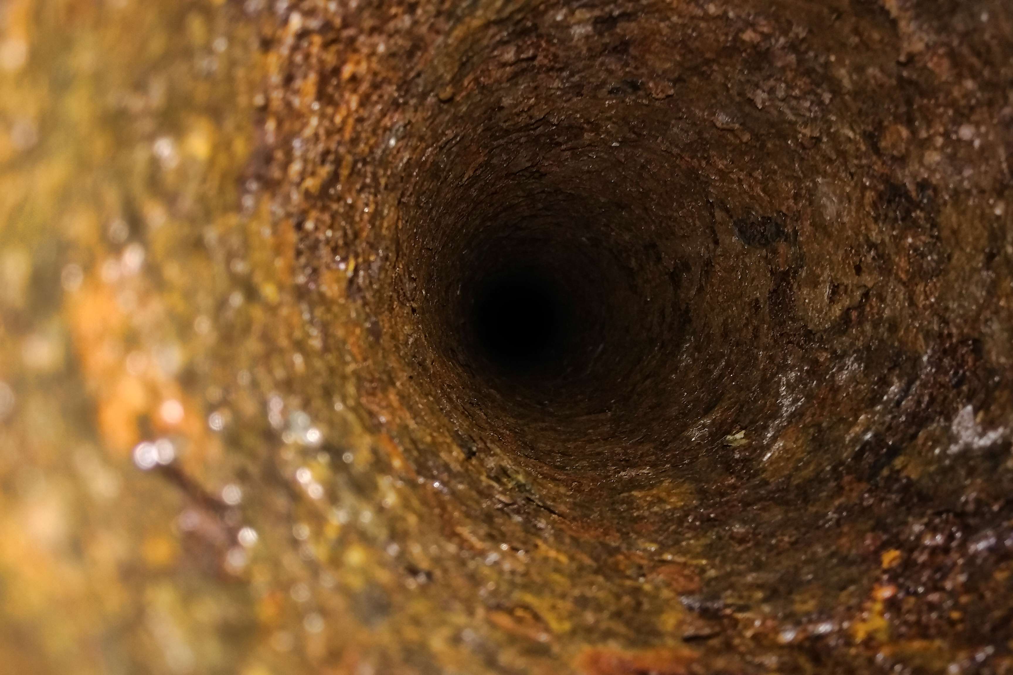 Look inside a rusted pipe.