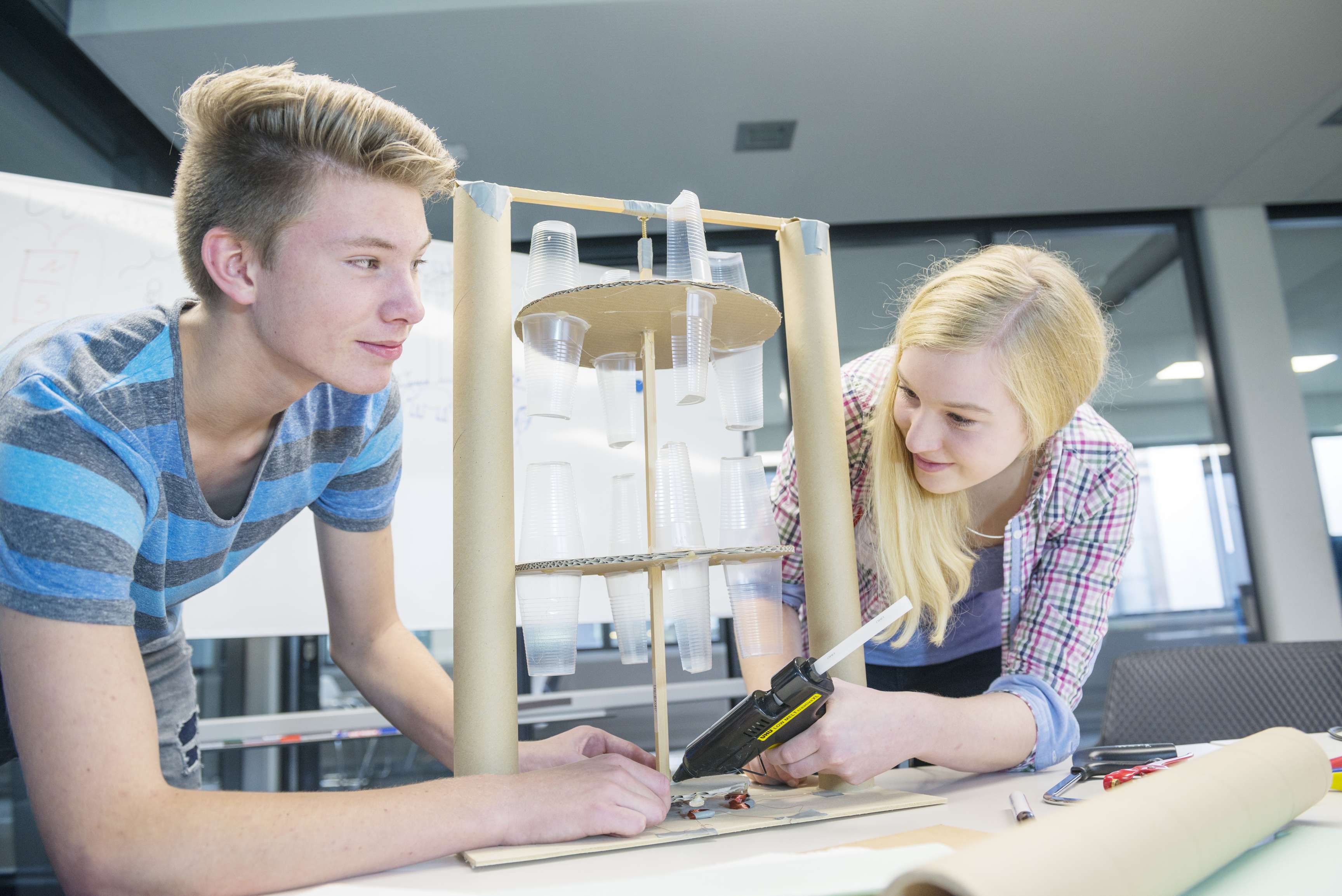 Two teenagers working on an experiment together