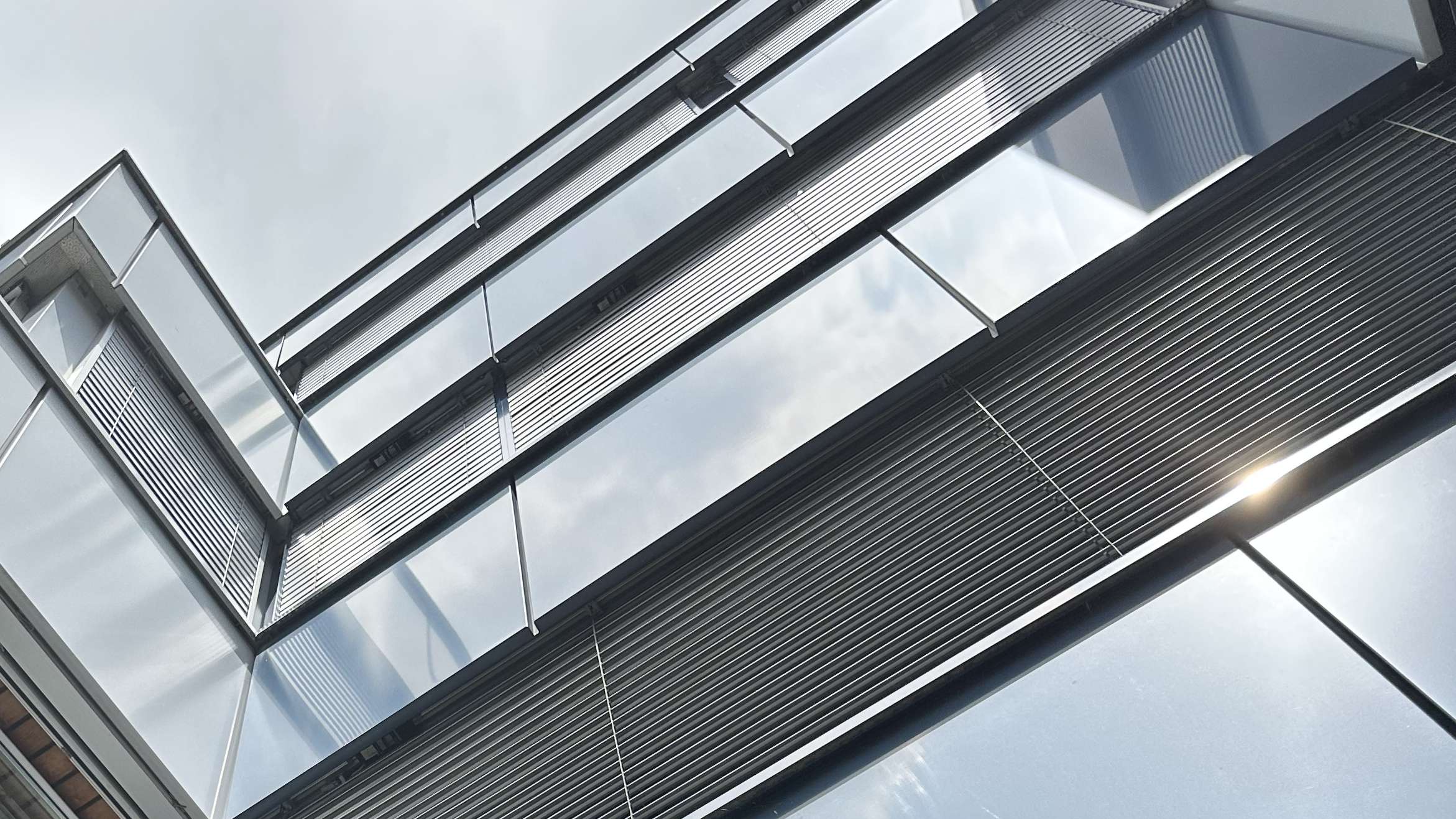 This photo shows the exterior facade of the ROSEN headquarters in Stans, Switzerland. The view is looking up at the facade from below.