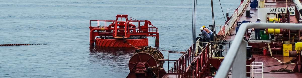 Picture of an offshore oil loading process from a single buoy mooring into an oil tanker.
